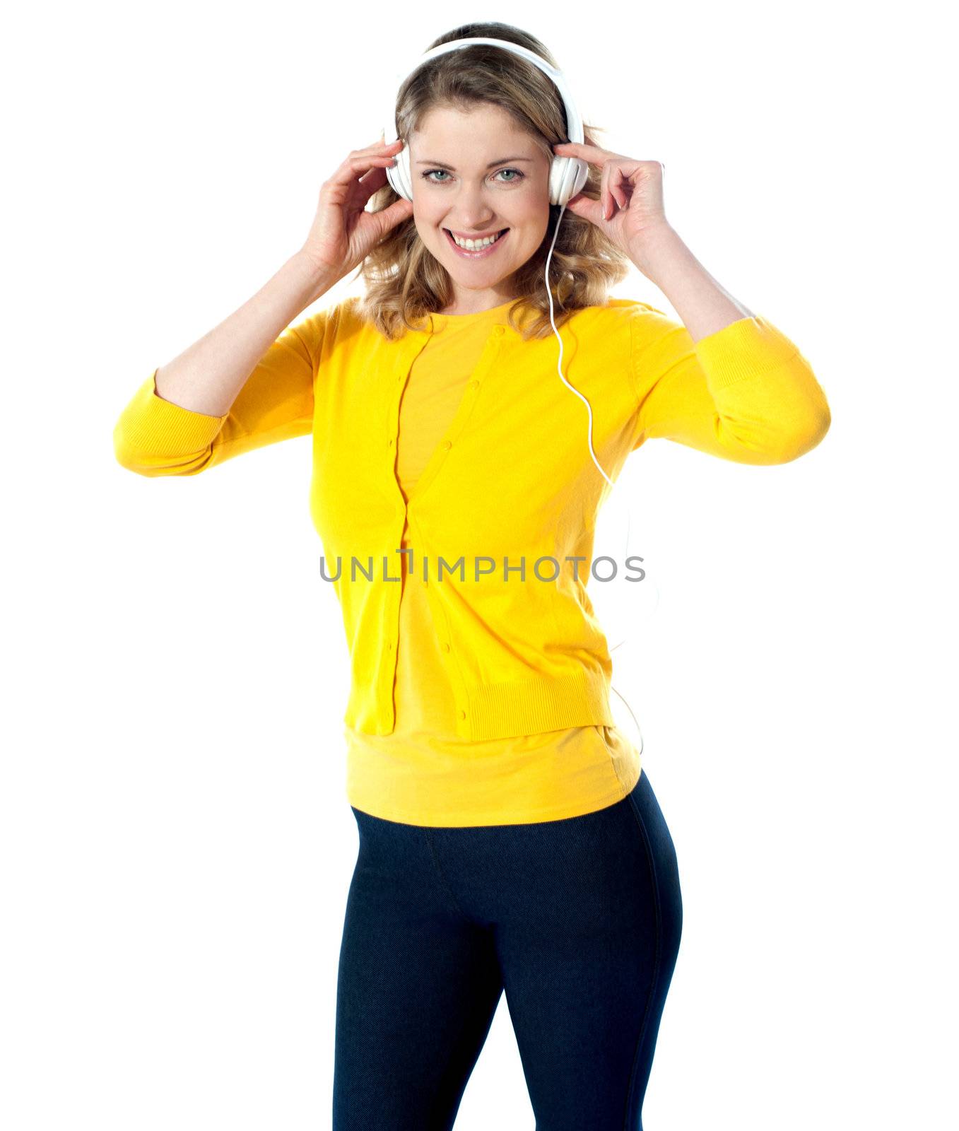 Gorgeous teenager enjoying music by stockyimages