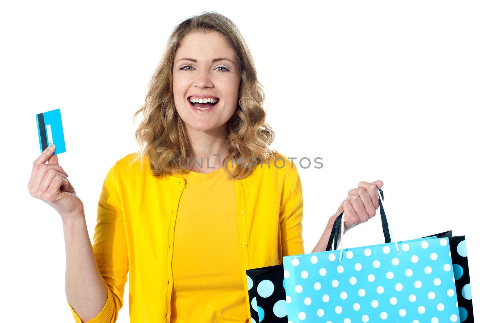 Happy shopaholic female laughing. Holidng credit-card and shopping bags