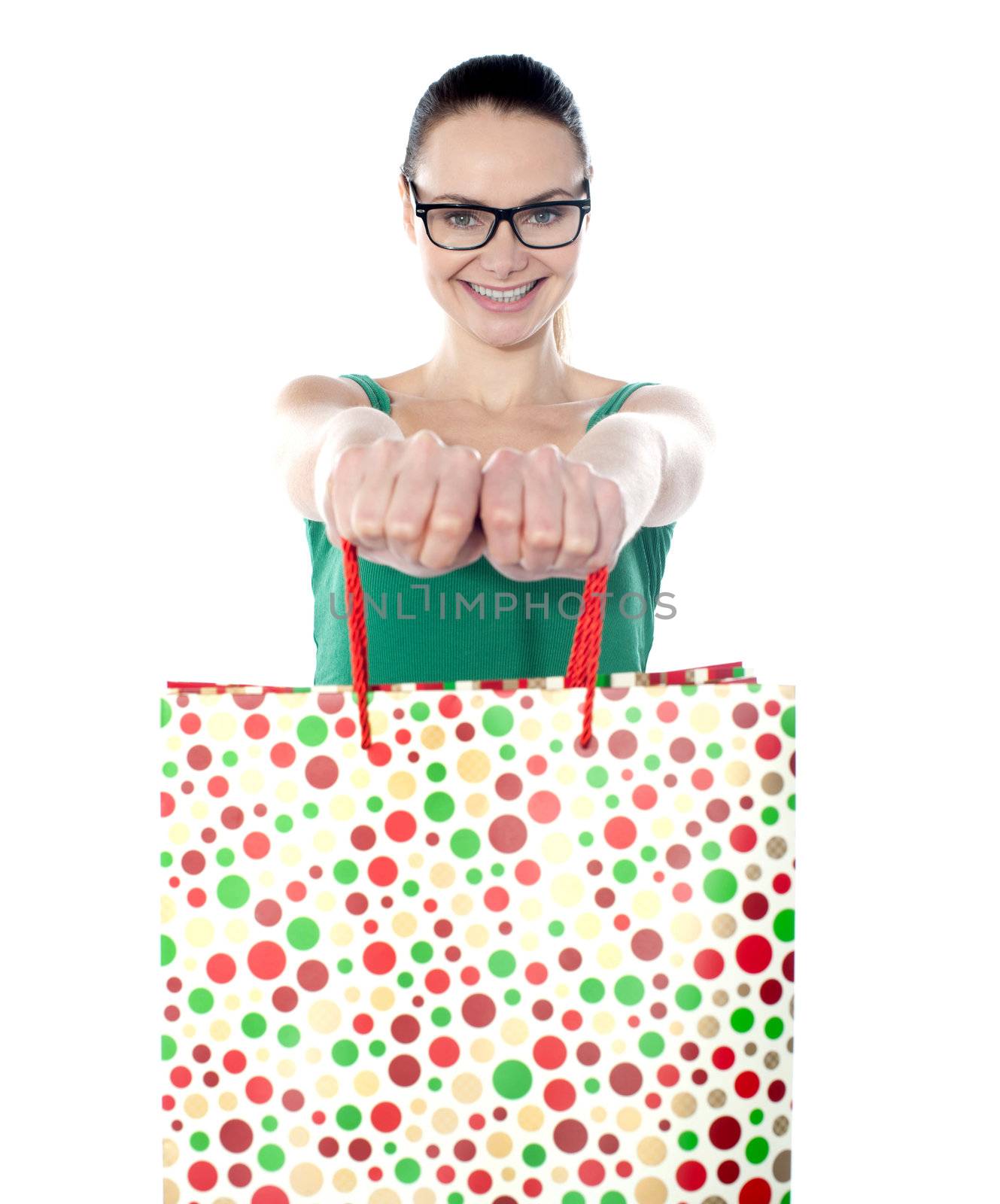 Portrait of stunning young woman carrying shopping bags against white background