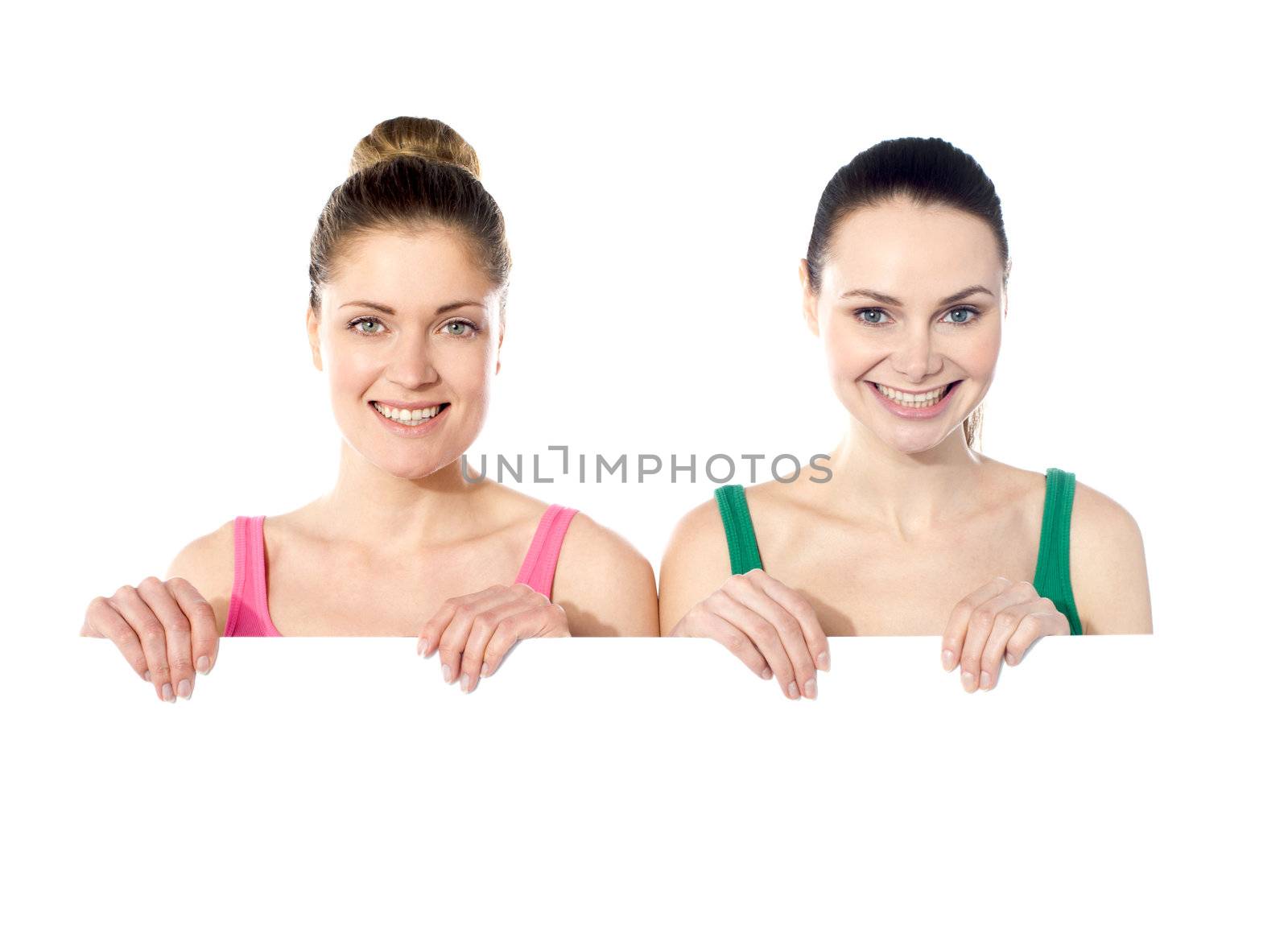Teen girls holding white board by stockyimages
