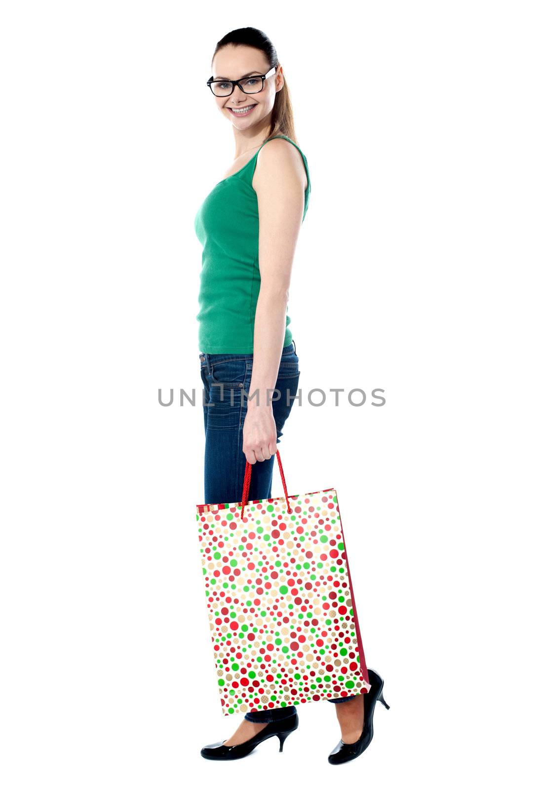 Beautiful shopping woman happy holding shopping bags by stockyimages