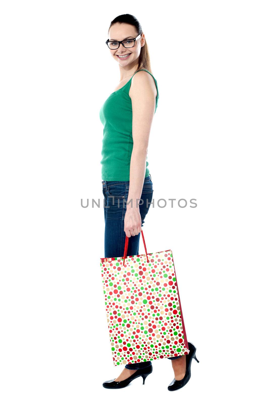 Beautiful shopping woman happy holding shopping bags isolated over white