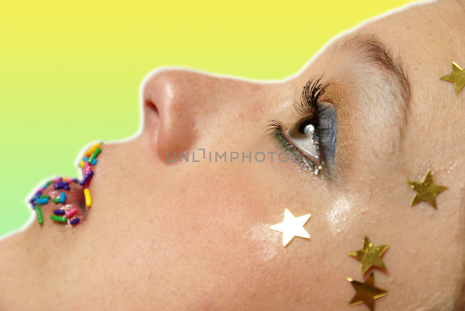 A closeup shot of a womans face with abstract makeup design.  Shallow DOF with focus on the eye.