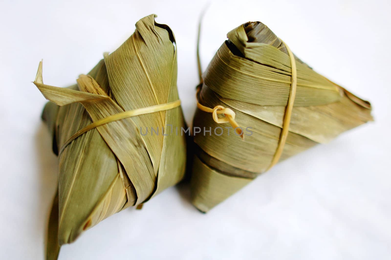 A pair of glutinous rice dumplings on a white background