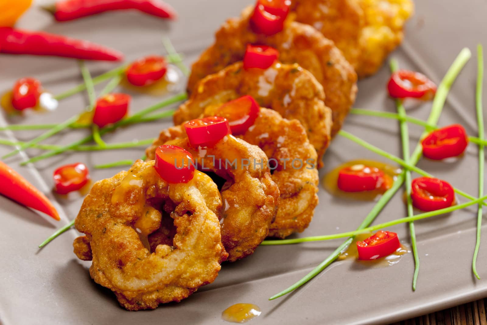 fried sepia rings in dough with chilli