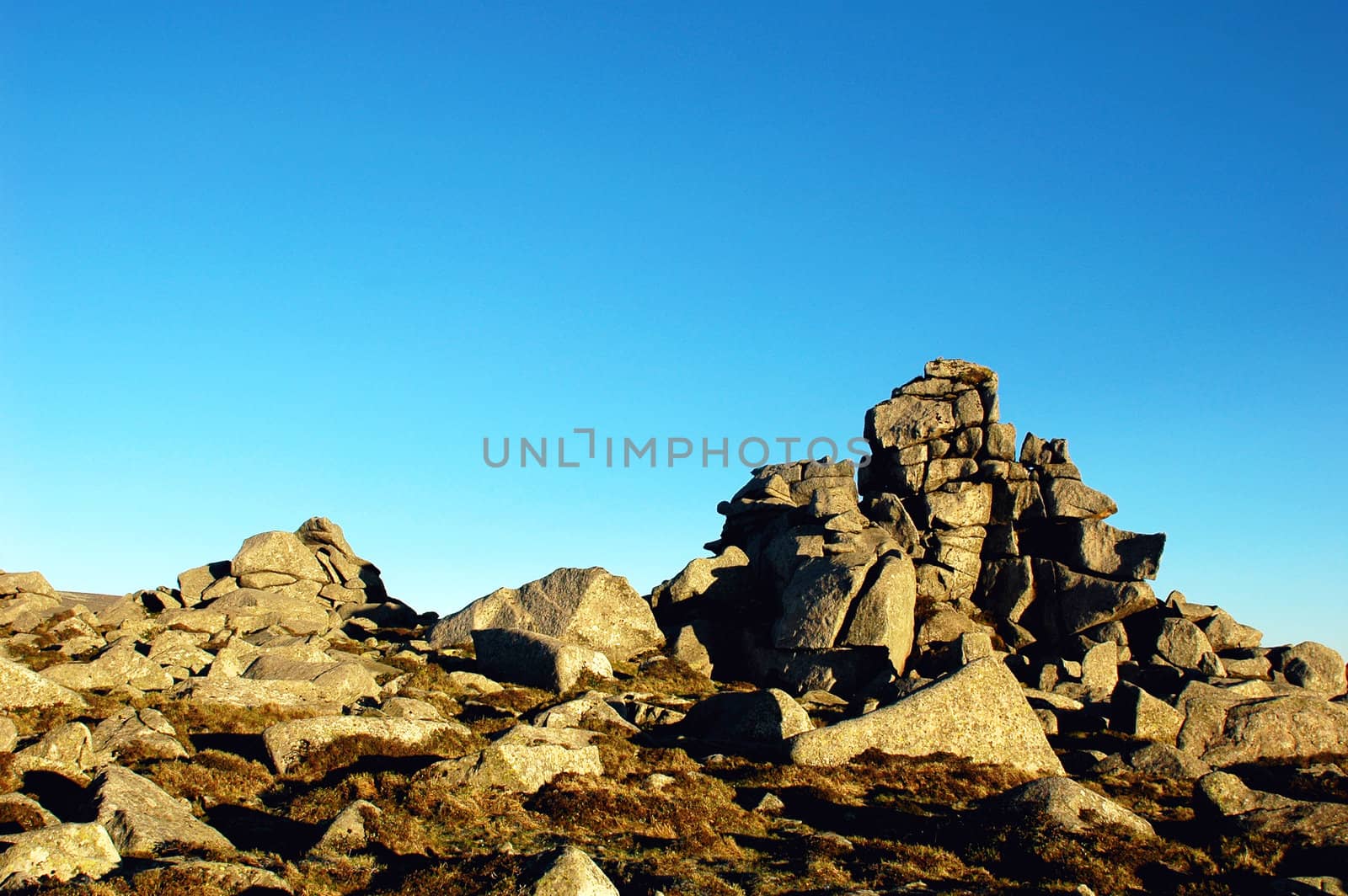 Huge rocks on the top of the mountains against blue sky