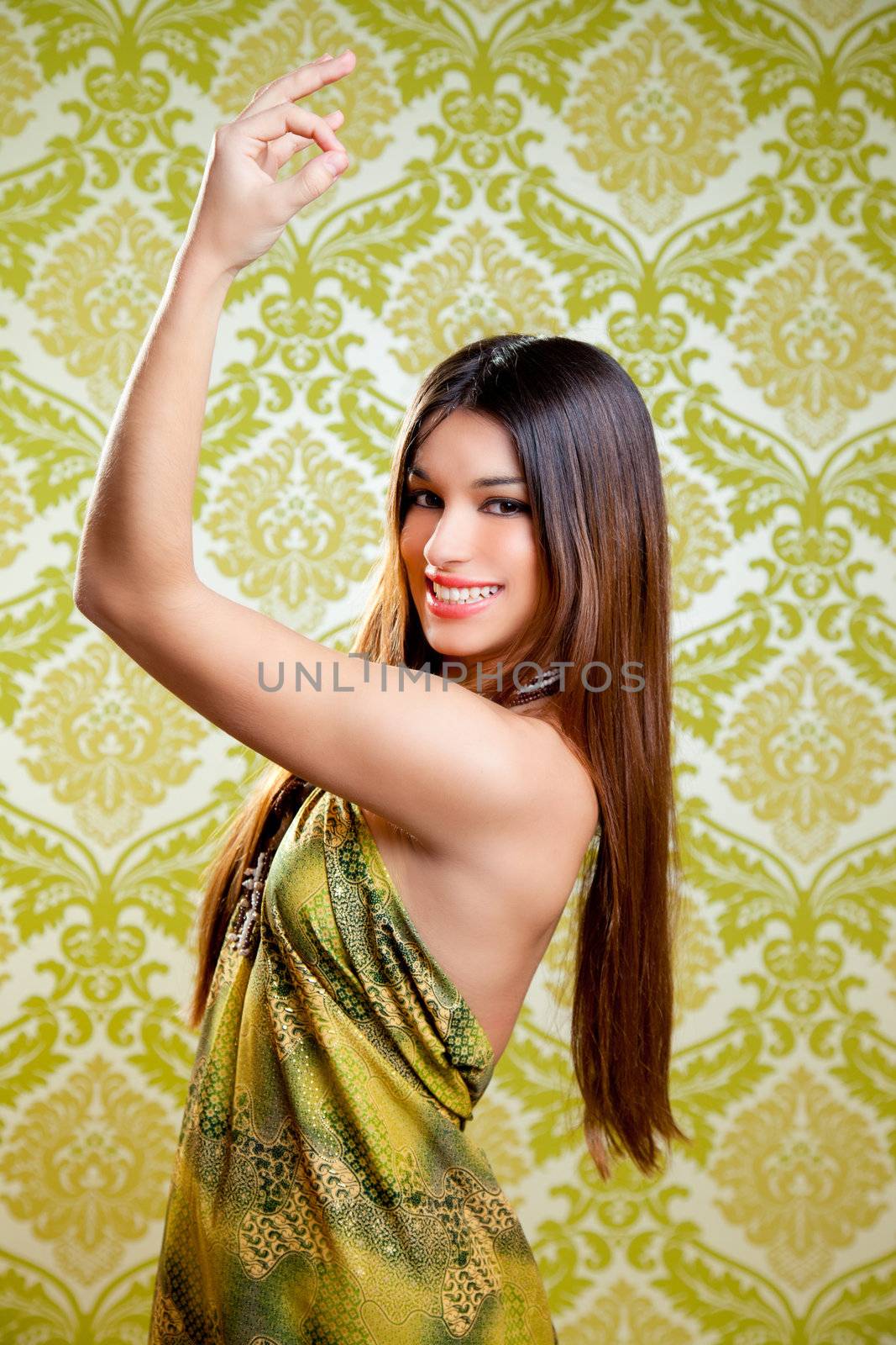 Asian Indian brunette girl with long hair dancing with hands up