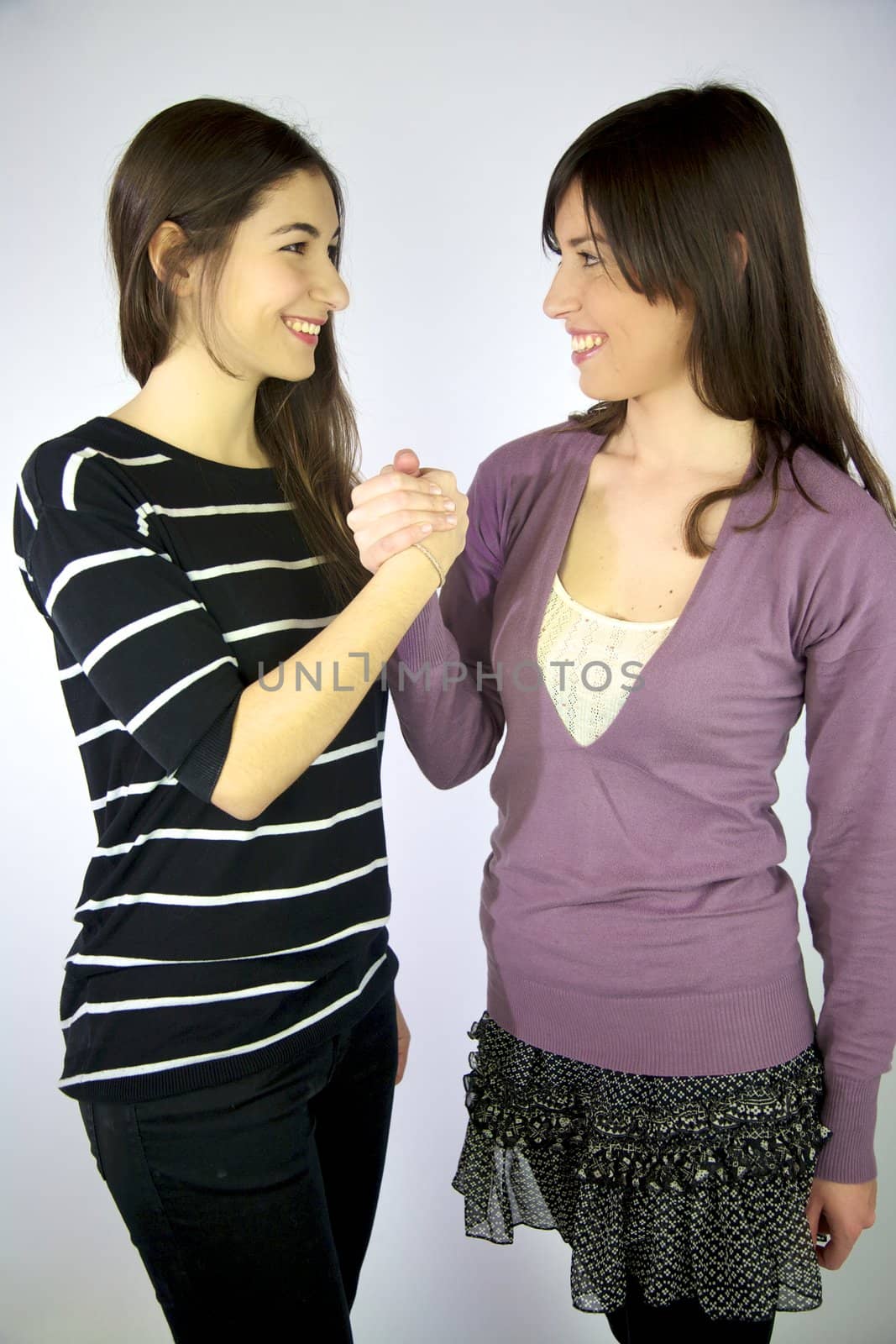 Female models holding hand sign of friendship happy