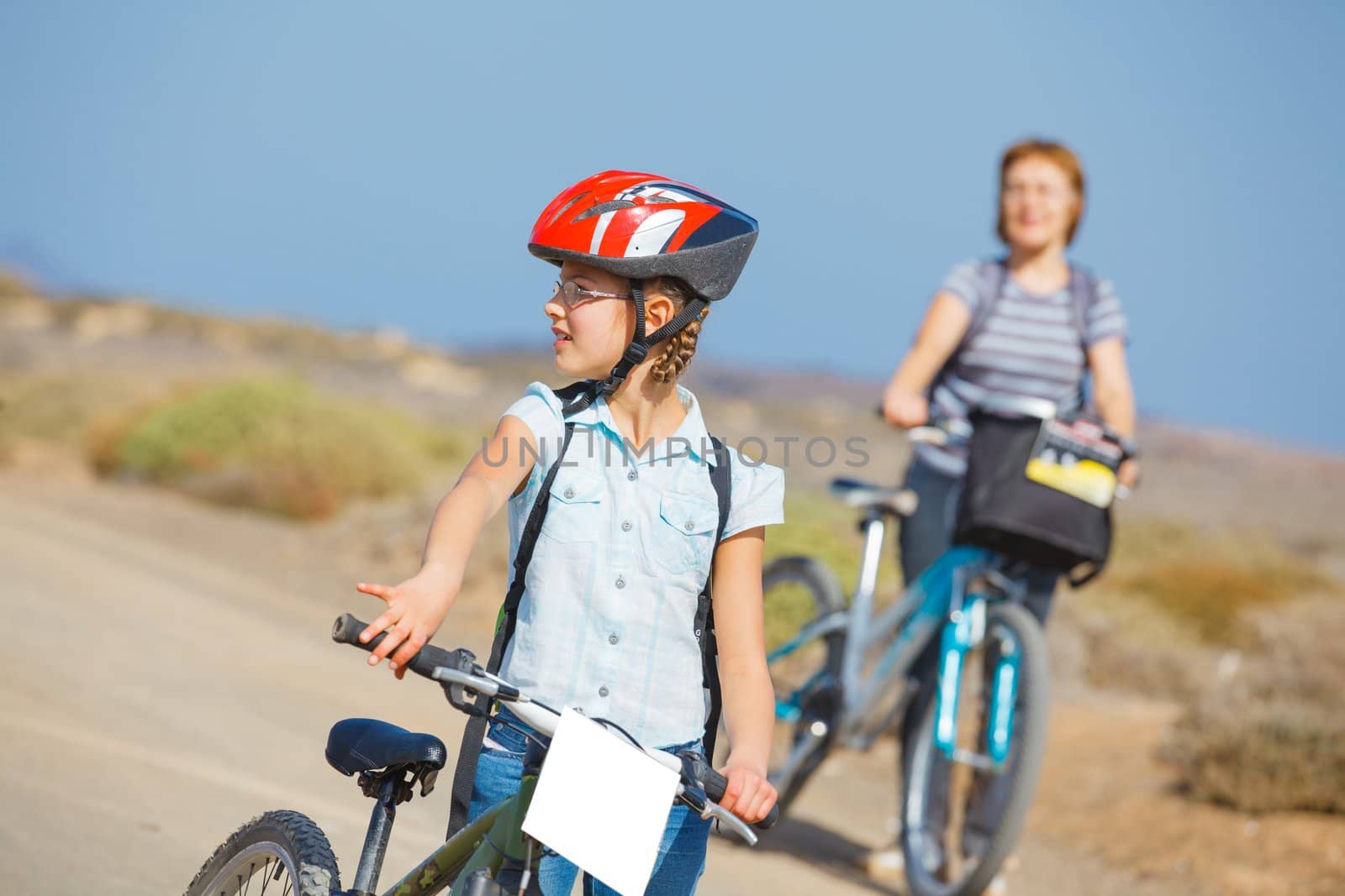 Beautiful girl and her grandmother on bikes. Lanzarote