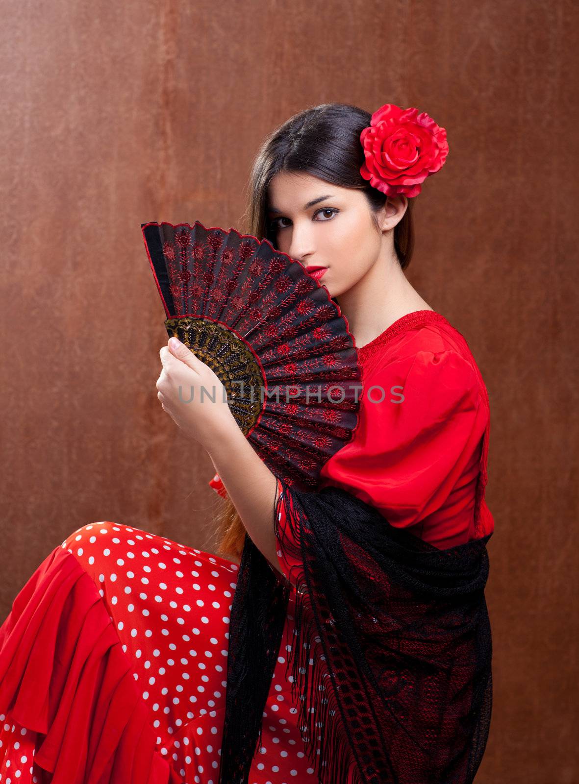 Flamenco dancer Spain woman gipsy with red rose and spanish hand fan
