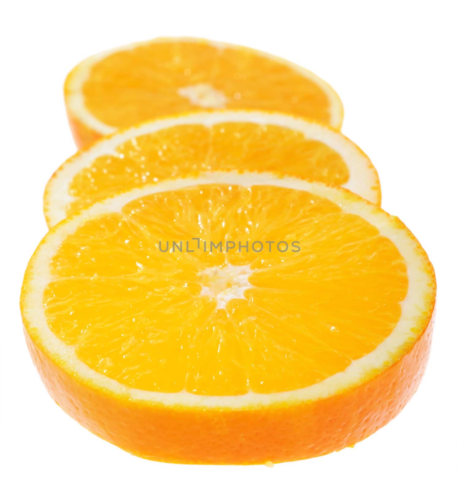 Juicy orange slices in very tasty view on white background. Focus on middСѓ of first slice. Shallow DoF.