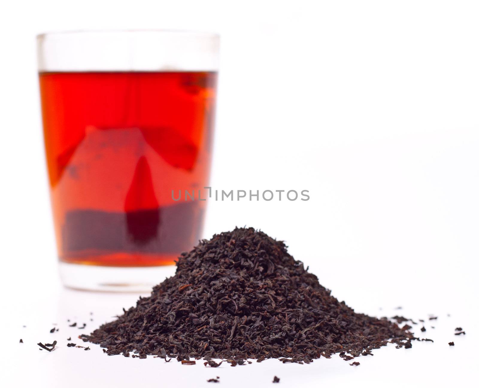 a scattering of black tea on a white background