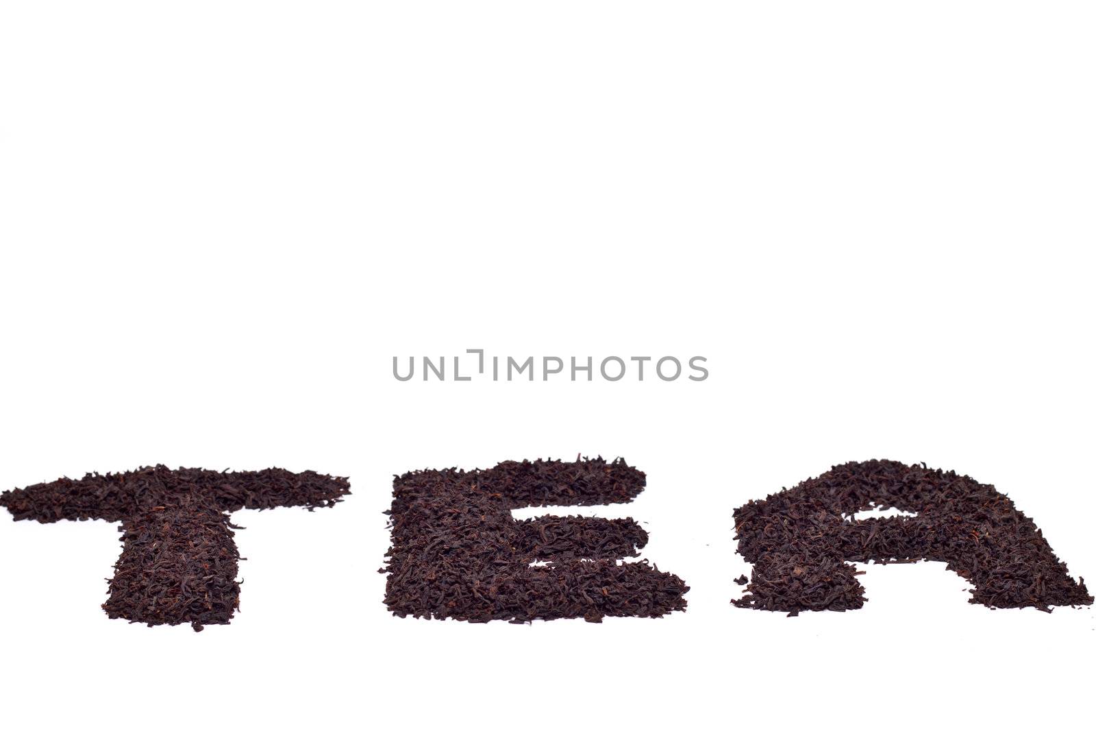 a scattering of black tea on a white background