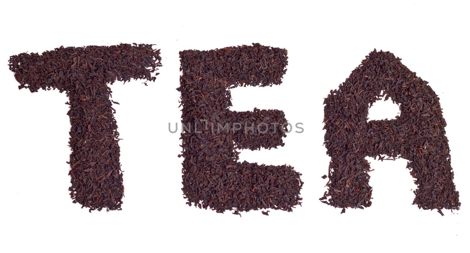 a scattering of black tea on a white background