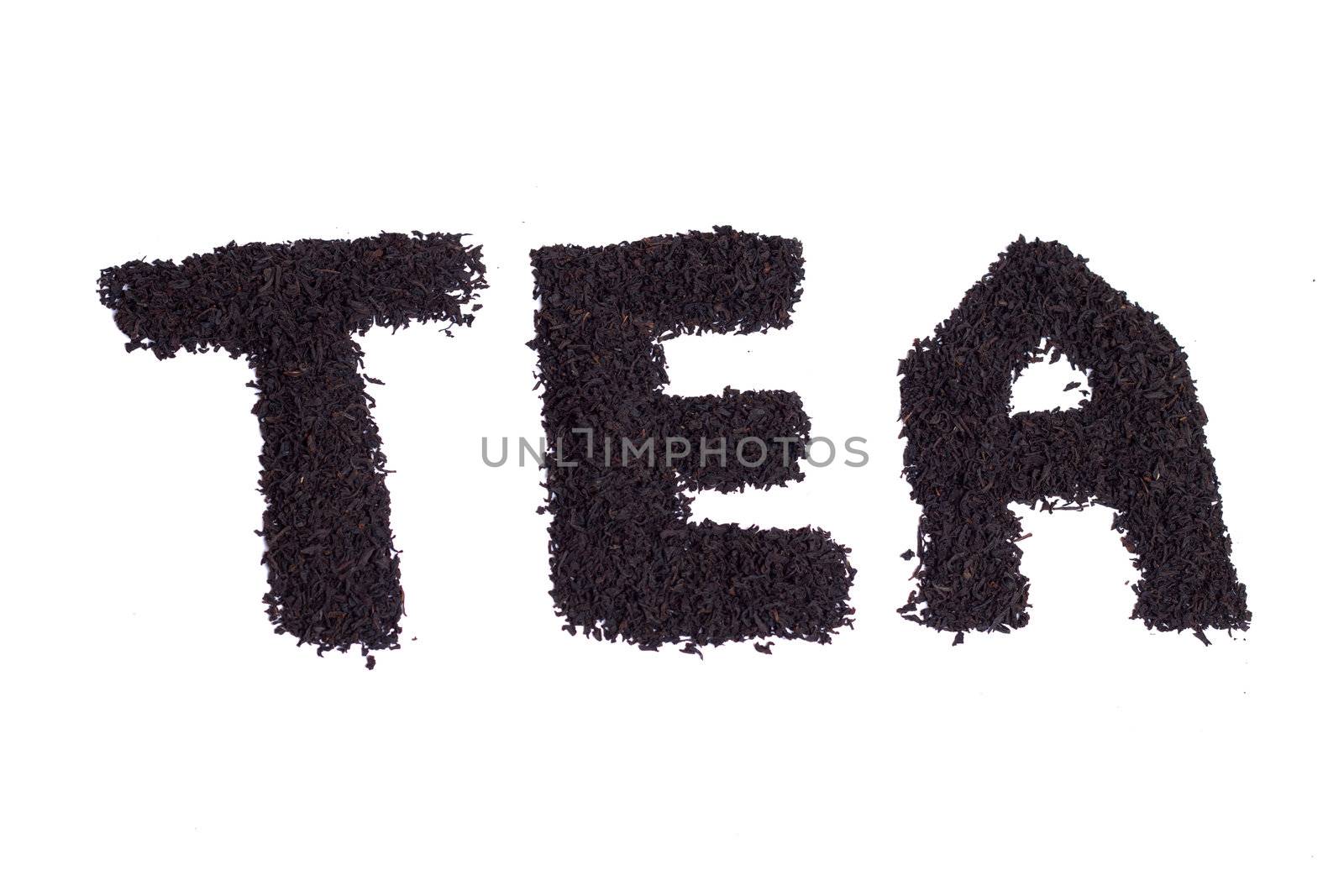 a scattering of black tea on a white background