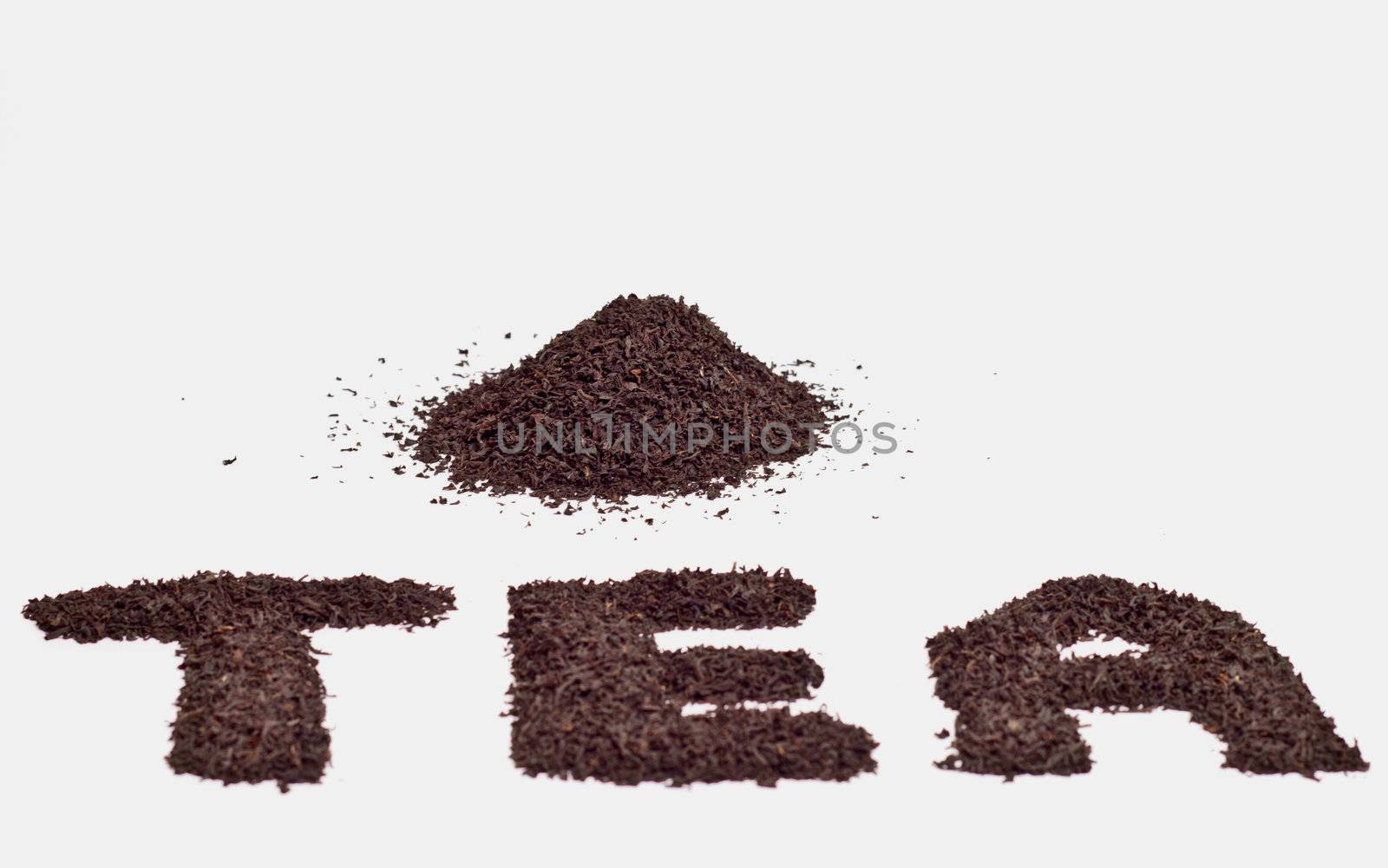 a scattering of black tea on a white background