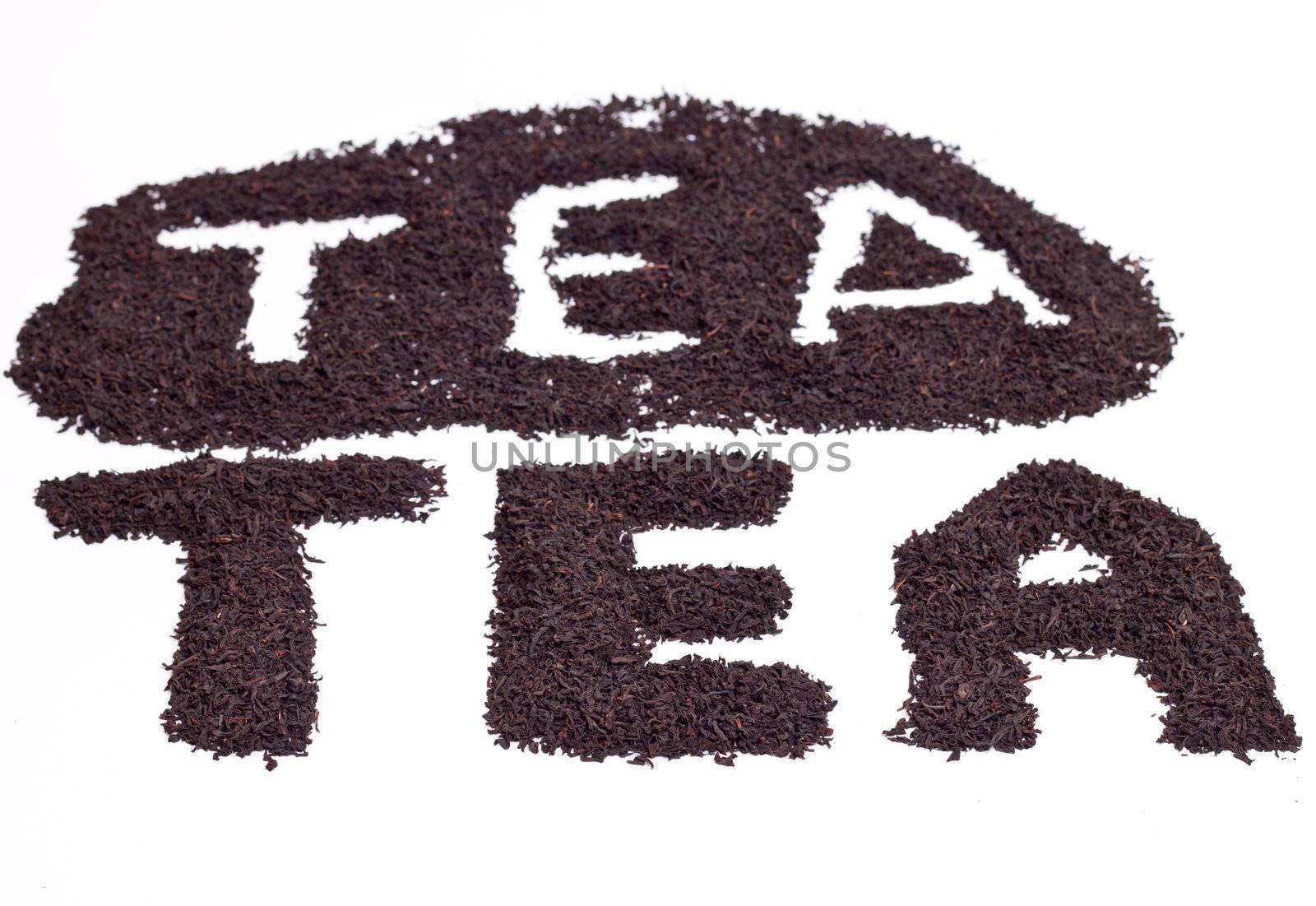 a scattering of black tea on a white background