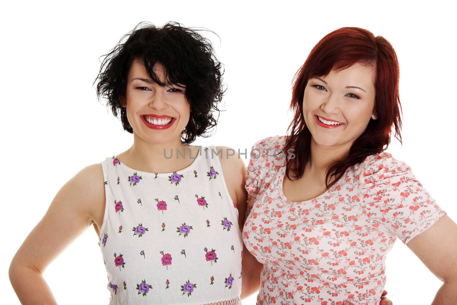 Two happy woman posing over white background.