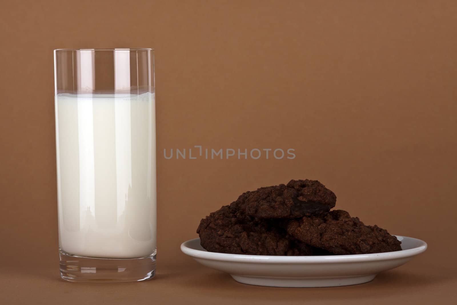 chocolate cookies with a glass of milk by juniart