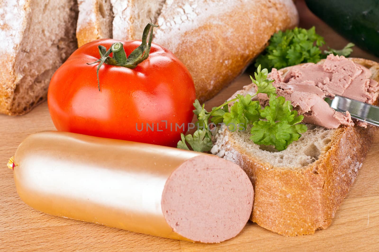 breakfast or lunch with mixed vegetables, sausage and a knife by juniart