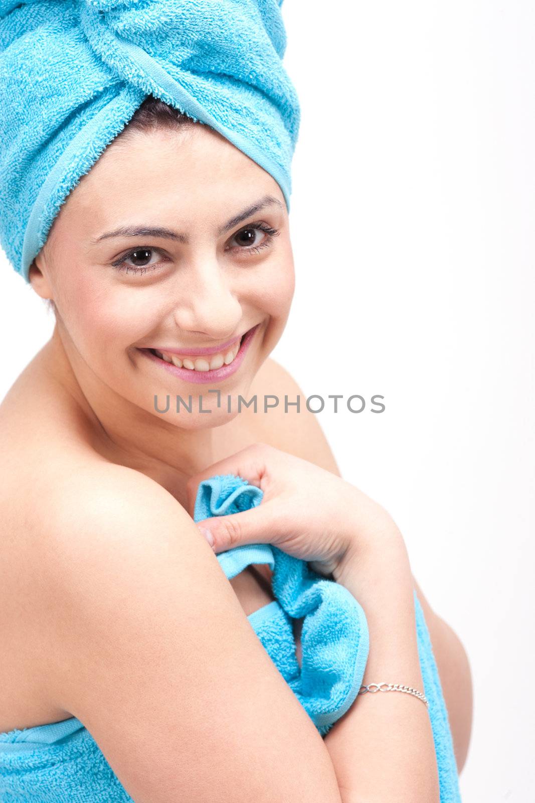 young beautiful woman with a towel doing wellness