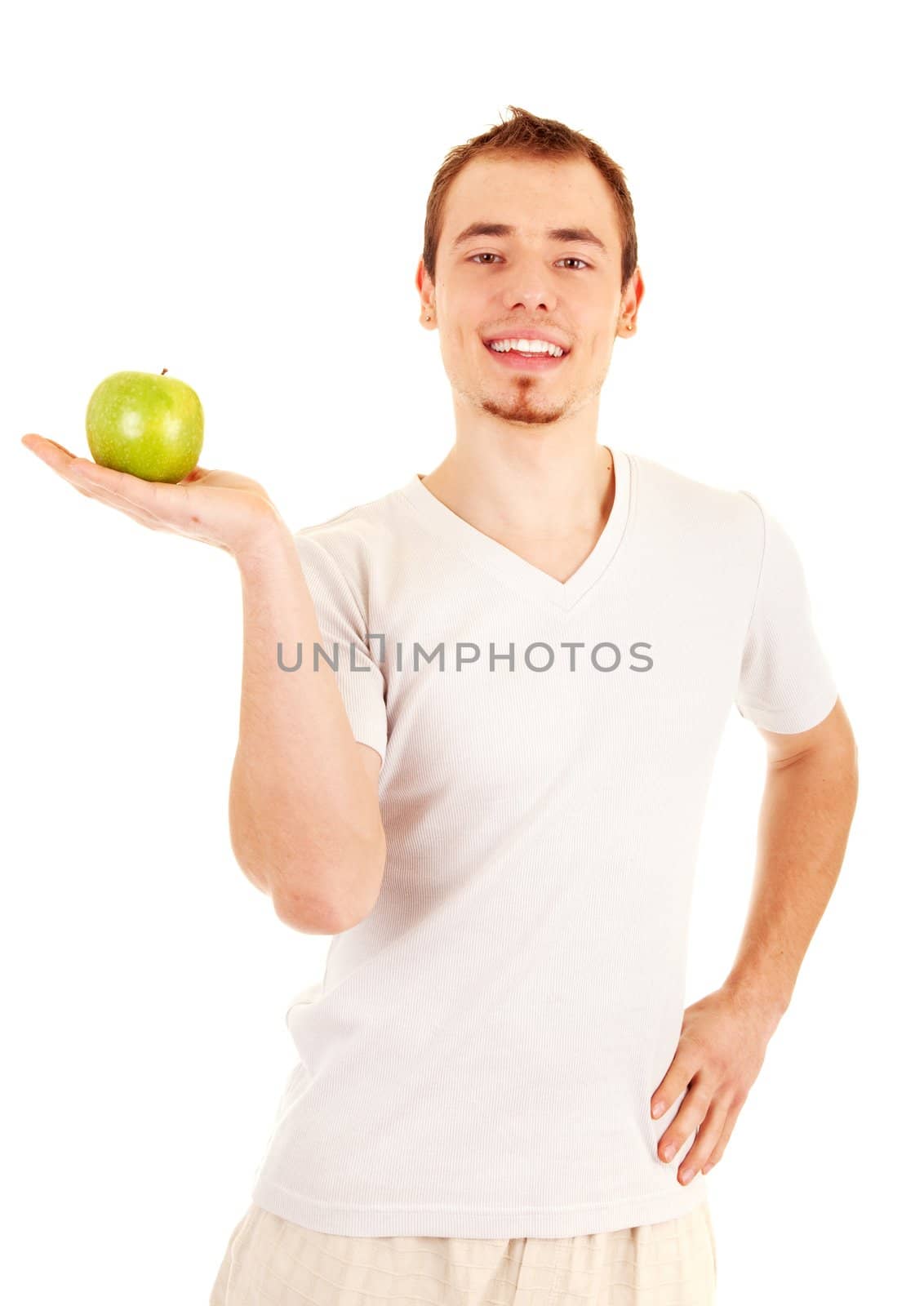 Young handsome man is holding a green apple on his palm. On white background.