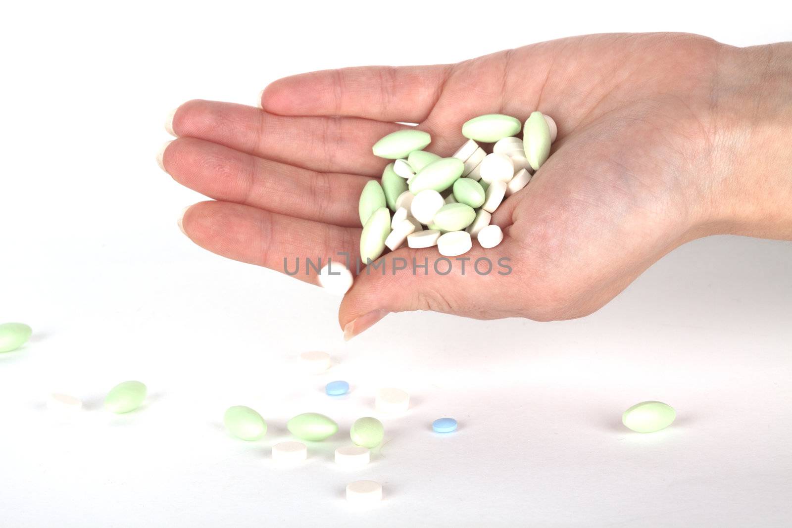 left hand with pills for healthcare
