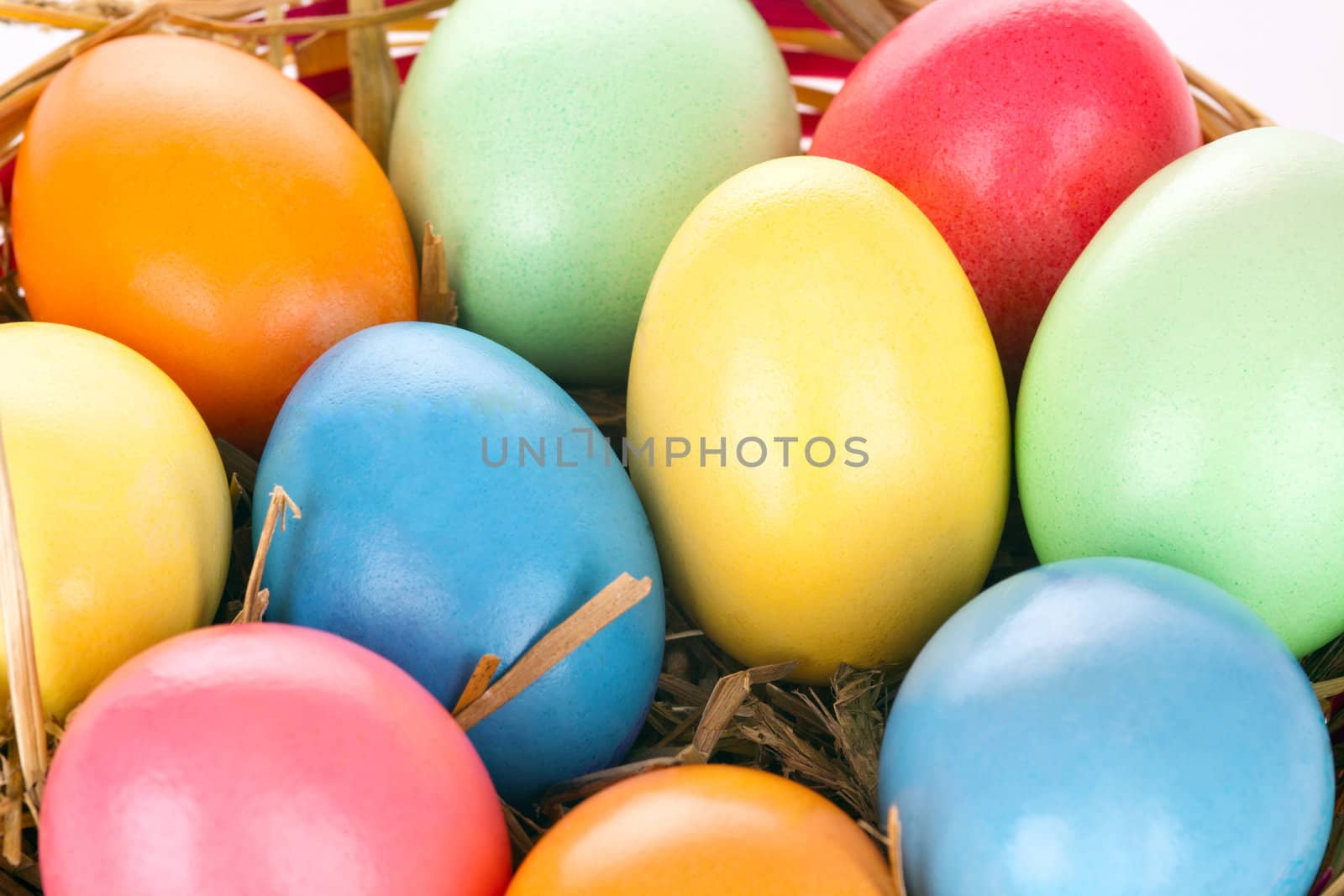 eastern eggs in different colours in a basket with a rabbit by juniart