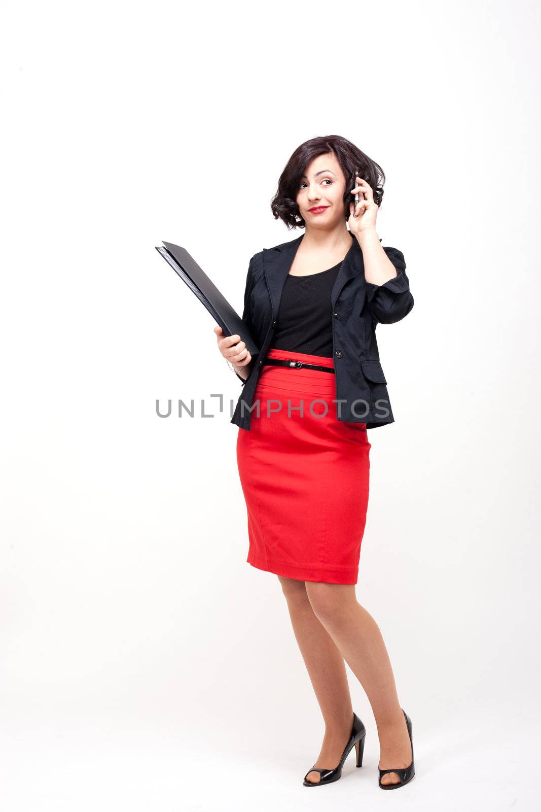 young business woman is talking on the mobile phone by juniart