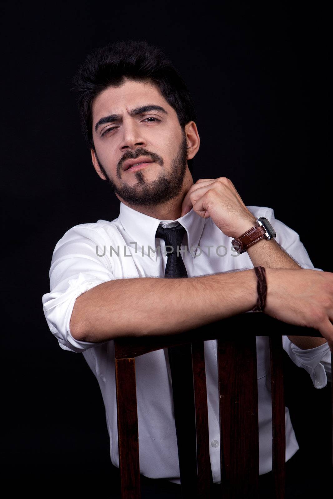 young successful business man with a suit isolated on black background