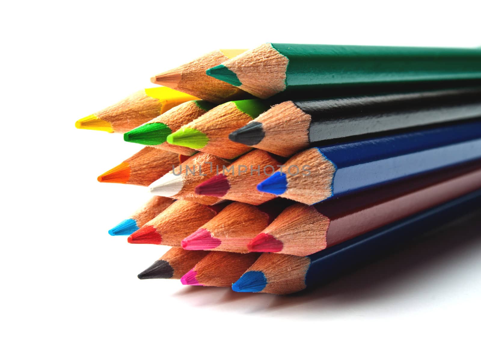 a bunch of colored pencils on a light background