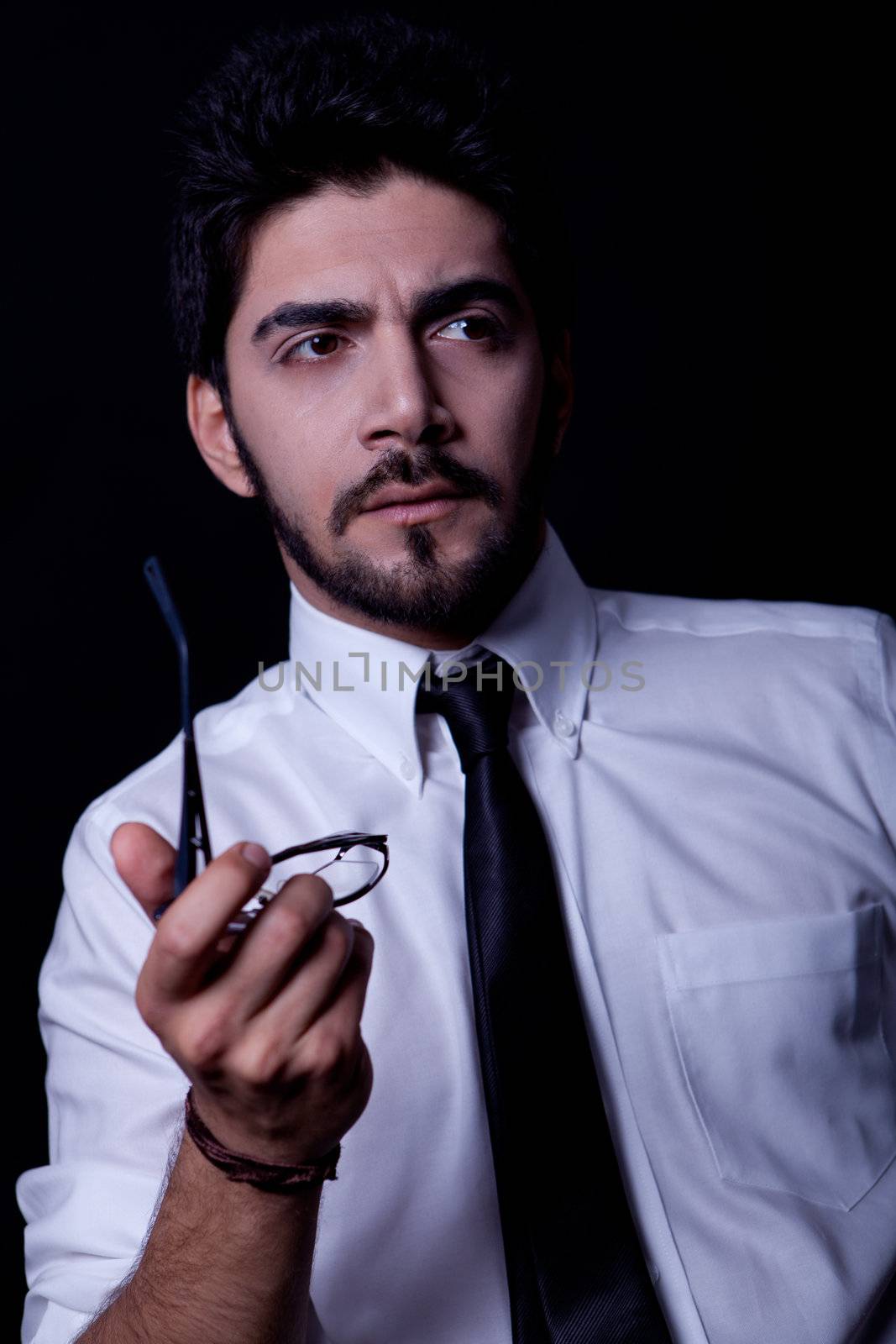 young successful business man with a suit isolated on black background