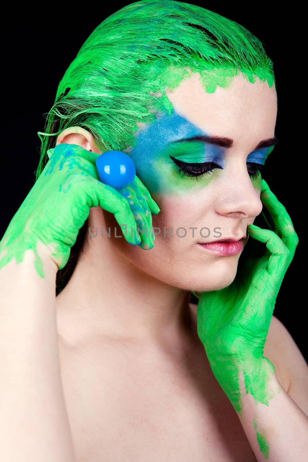 young beautiful woman with an extreme colorfull make up portrait