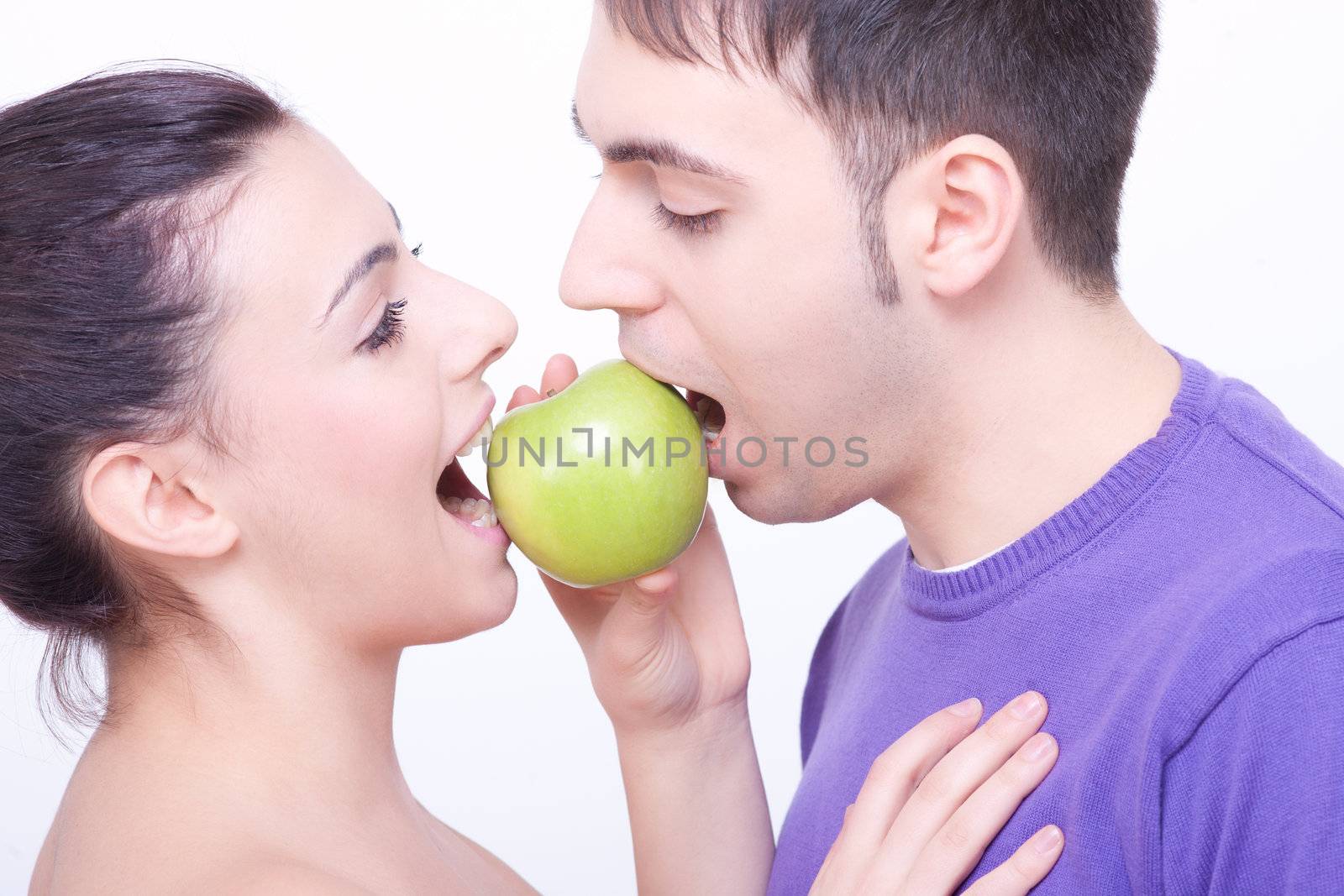 young couple with a green apple between their lips by juniart