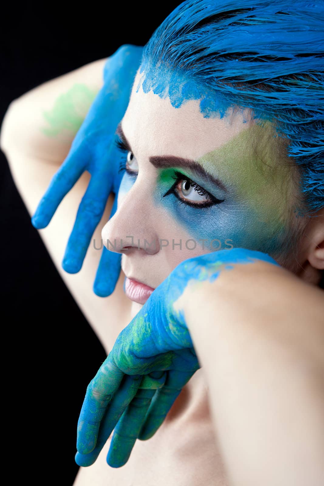 young beautiful woman with an extreme colorfull make up portrait