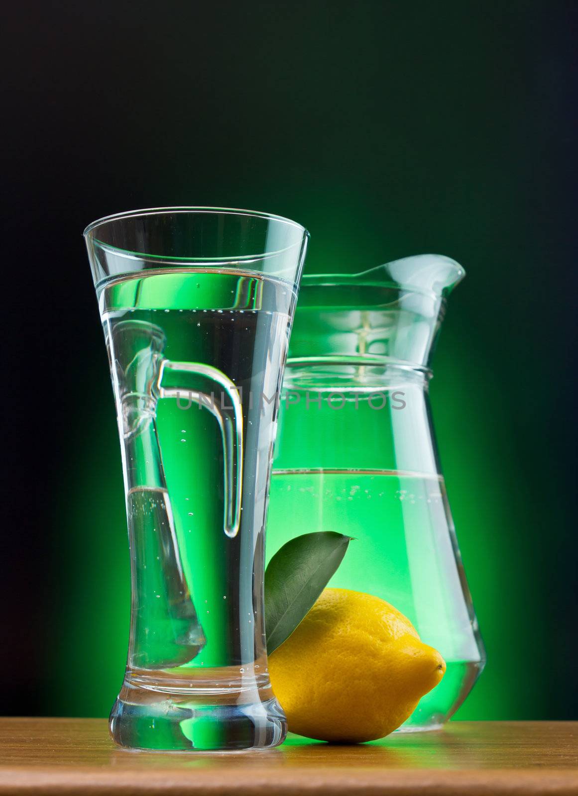 mineral water and lemon on a colored background