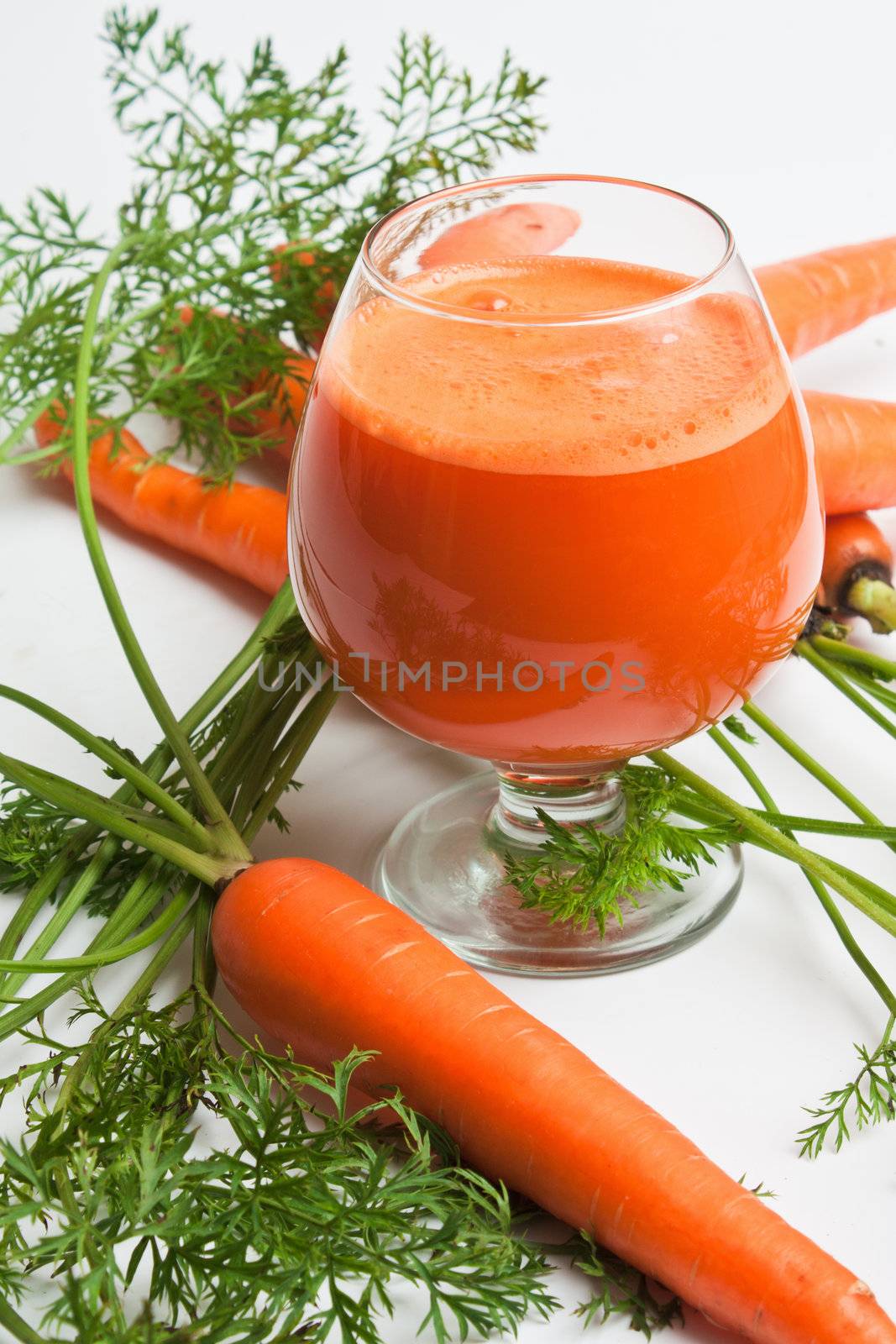 carrots and carrot juice in a glass