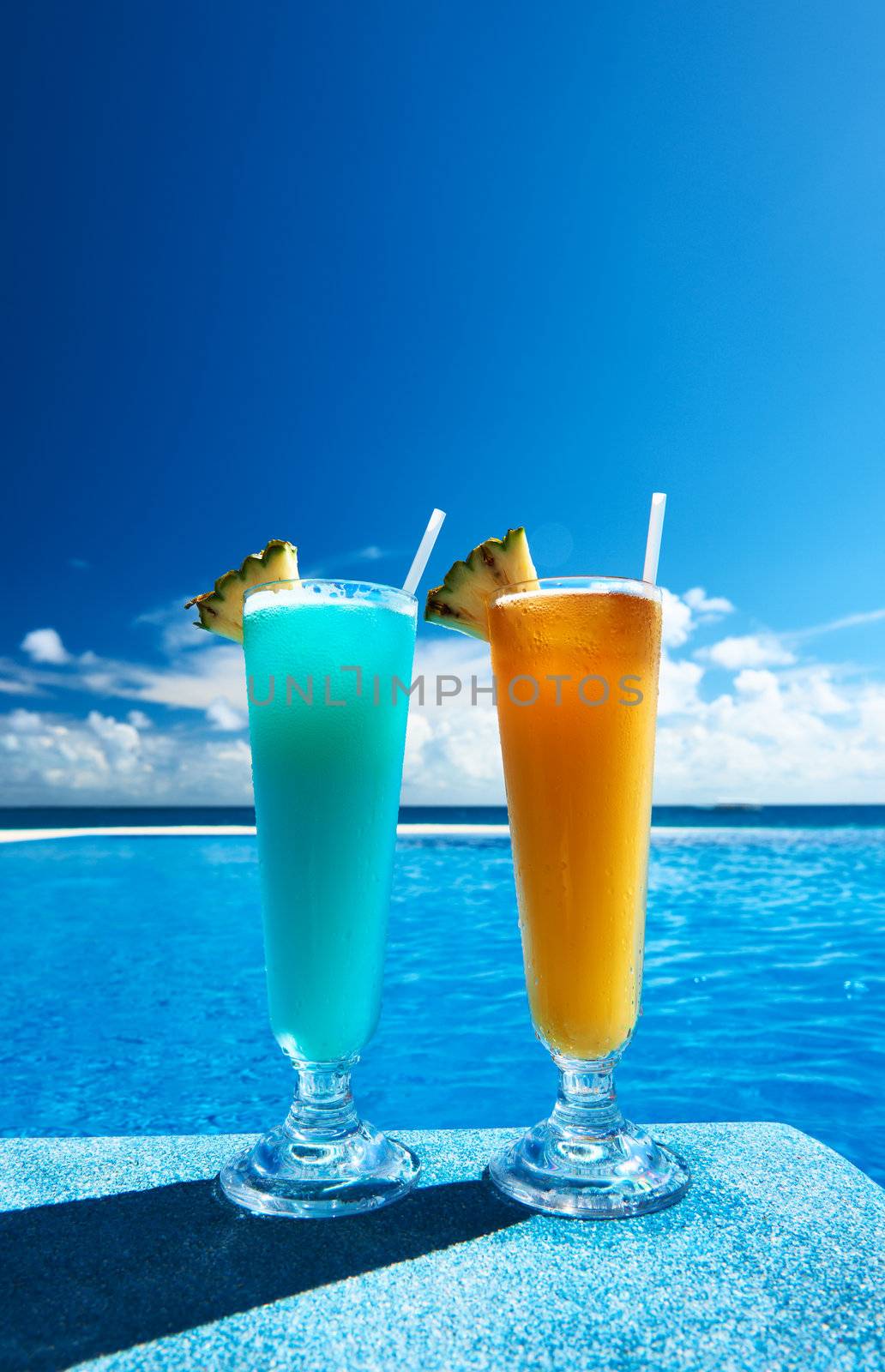 Cocktails near swimming pool by haveseen