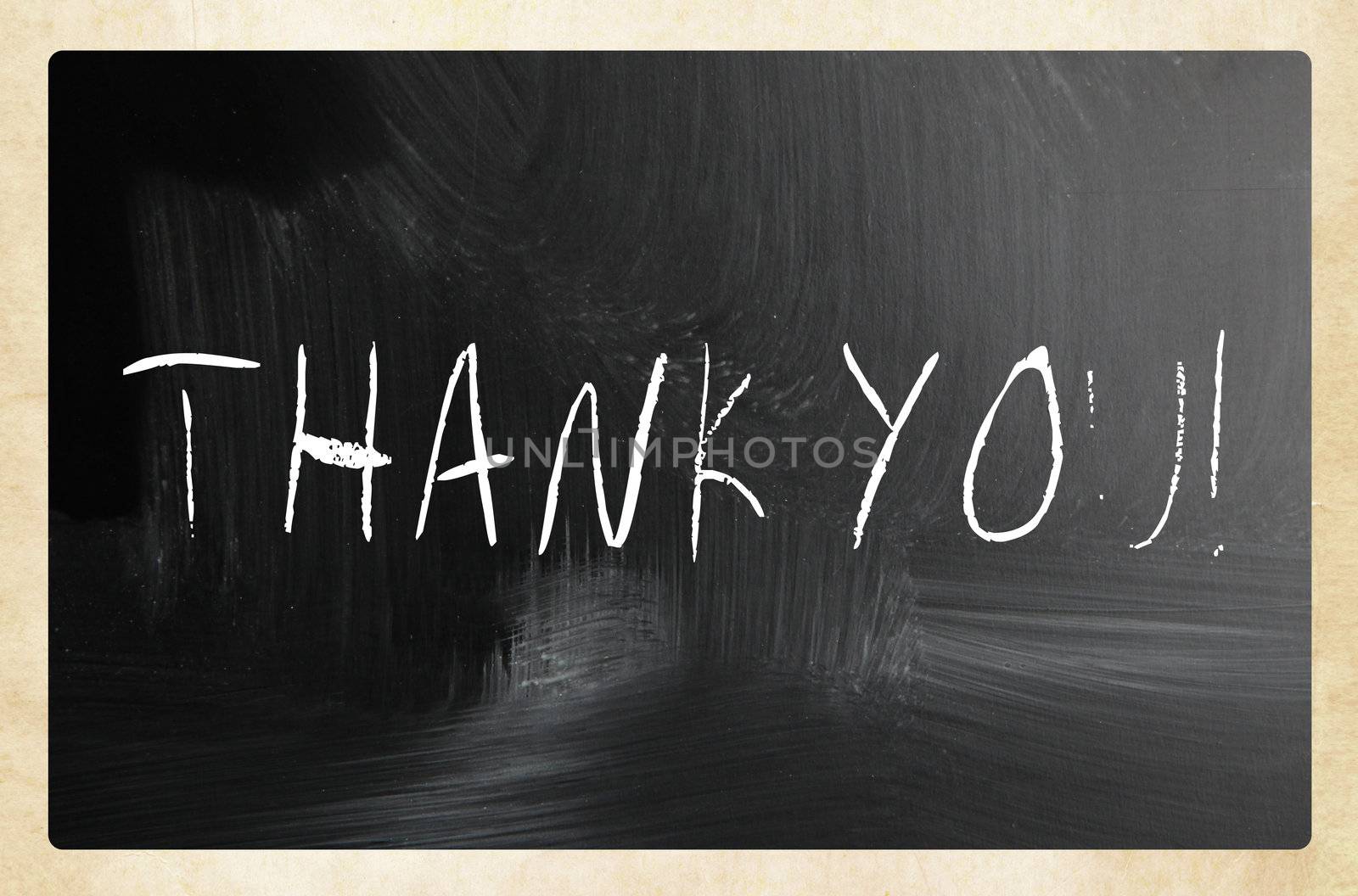 "Thank you" handwritten with white chalk on a blackboard by nenov
