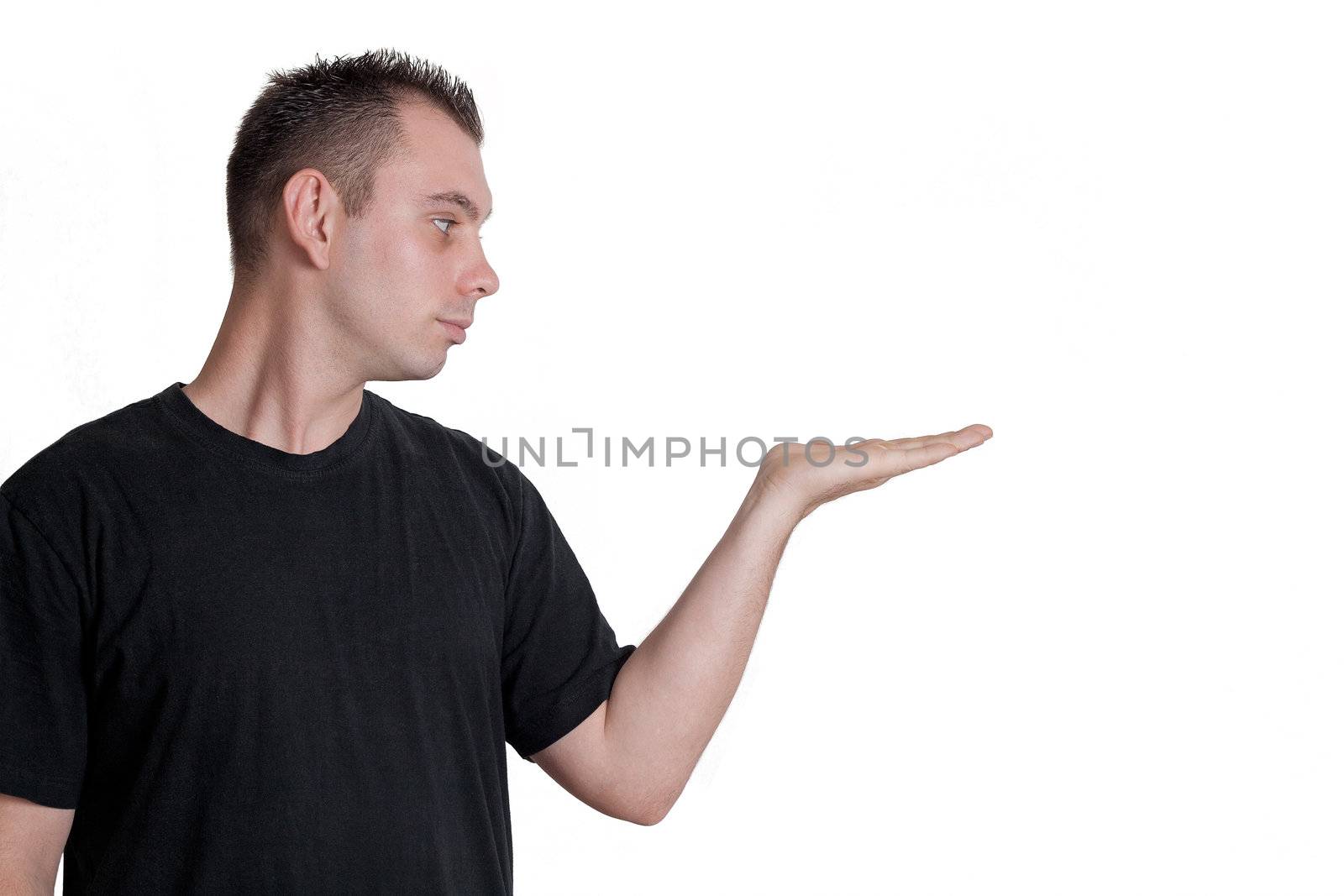 young man holding, showing something in his palm - isolated on white background