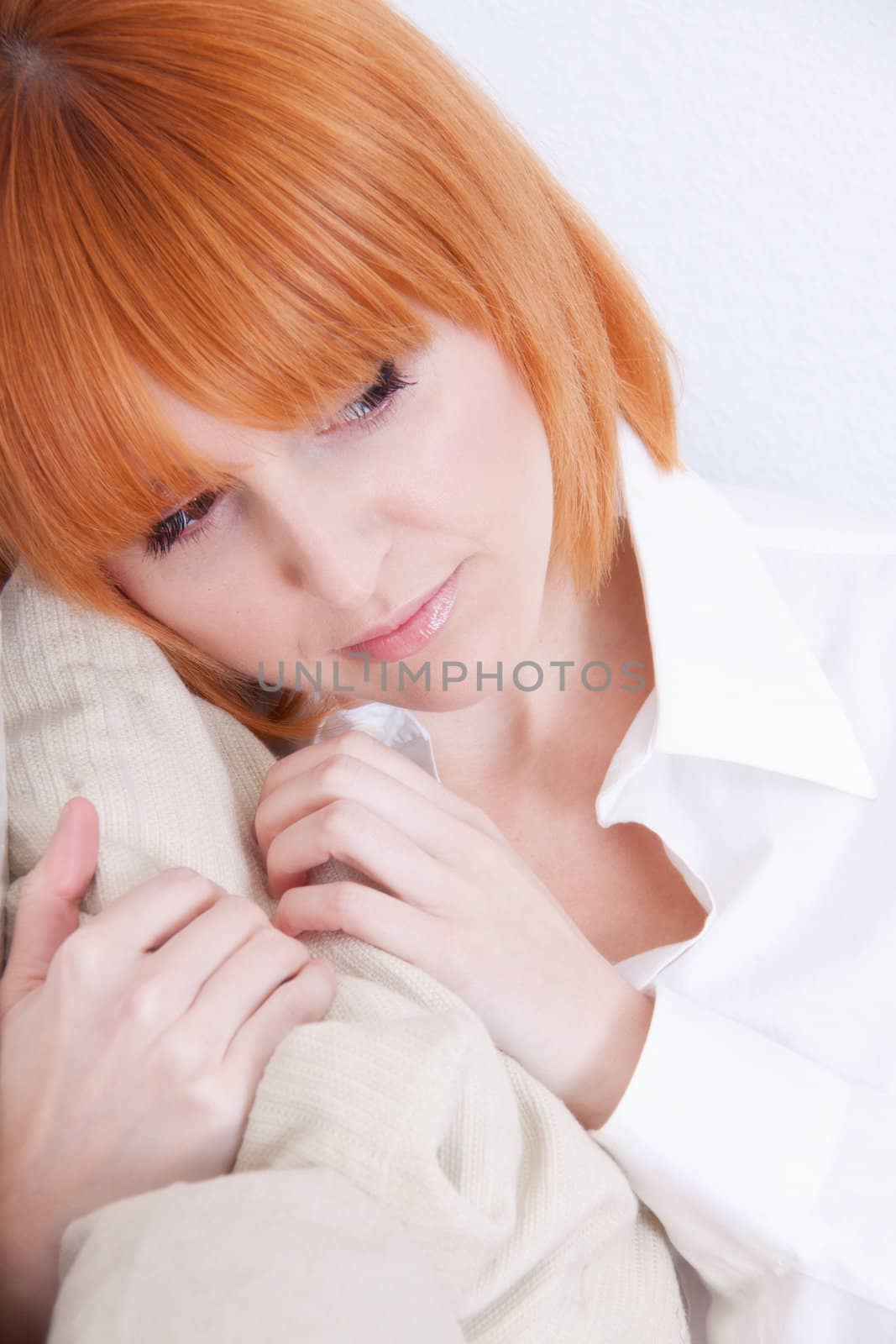 beautiful woman with red hair is dreaming if something 