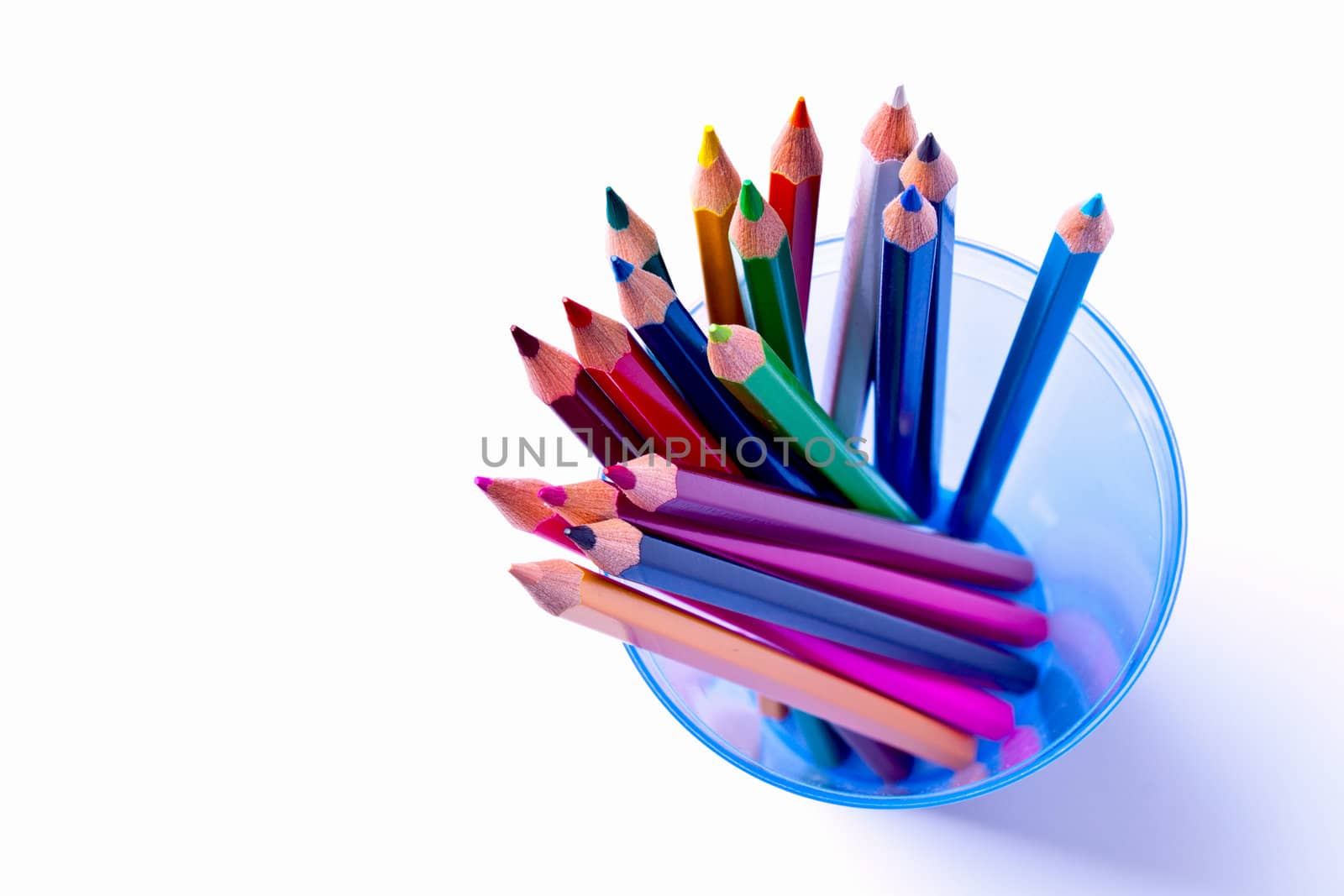 a bunch of colored pencils on a light background