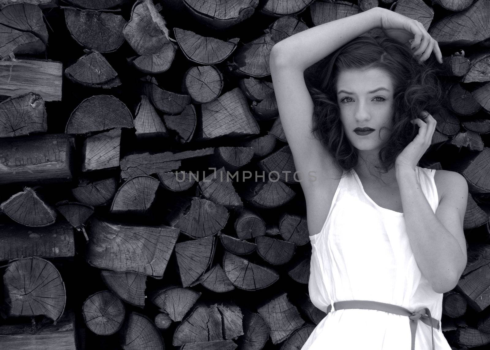 young beatiful woman in fashion outdoor in front of wood black and white by juniart