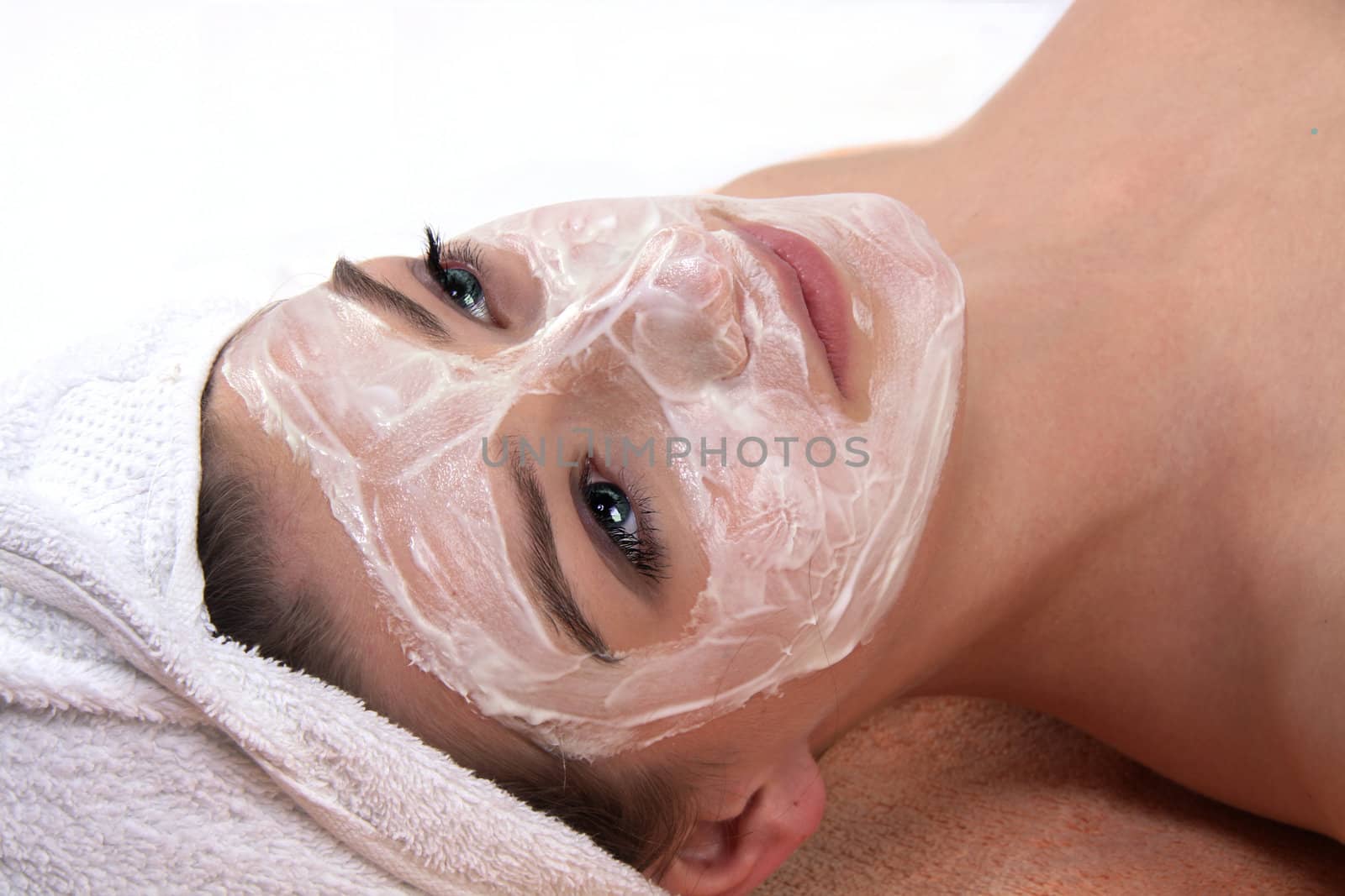 young beautiful woman with a towel doing wellness