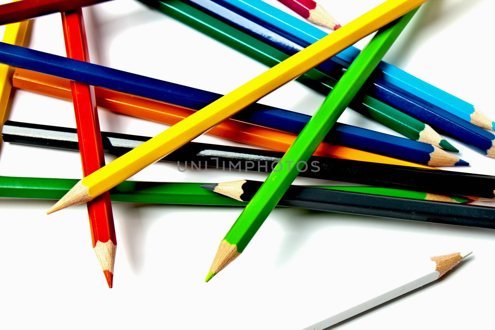 a bunch of colored pencils on a light background