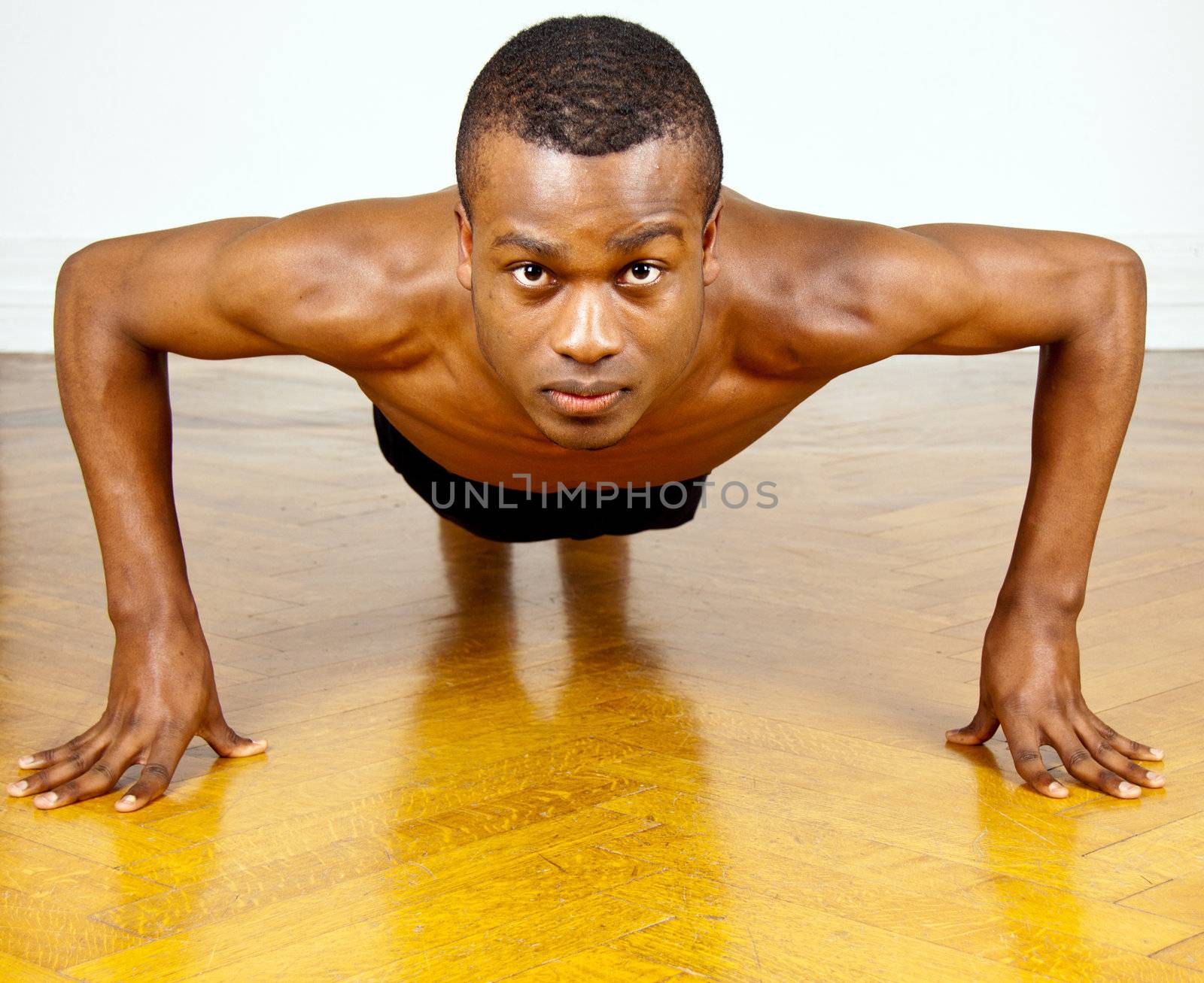 young man with black skin ist doing fittness by juniart