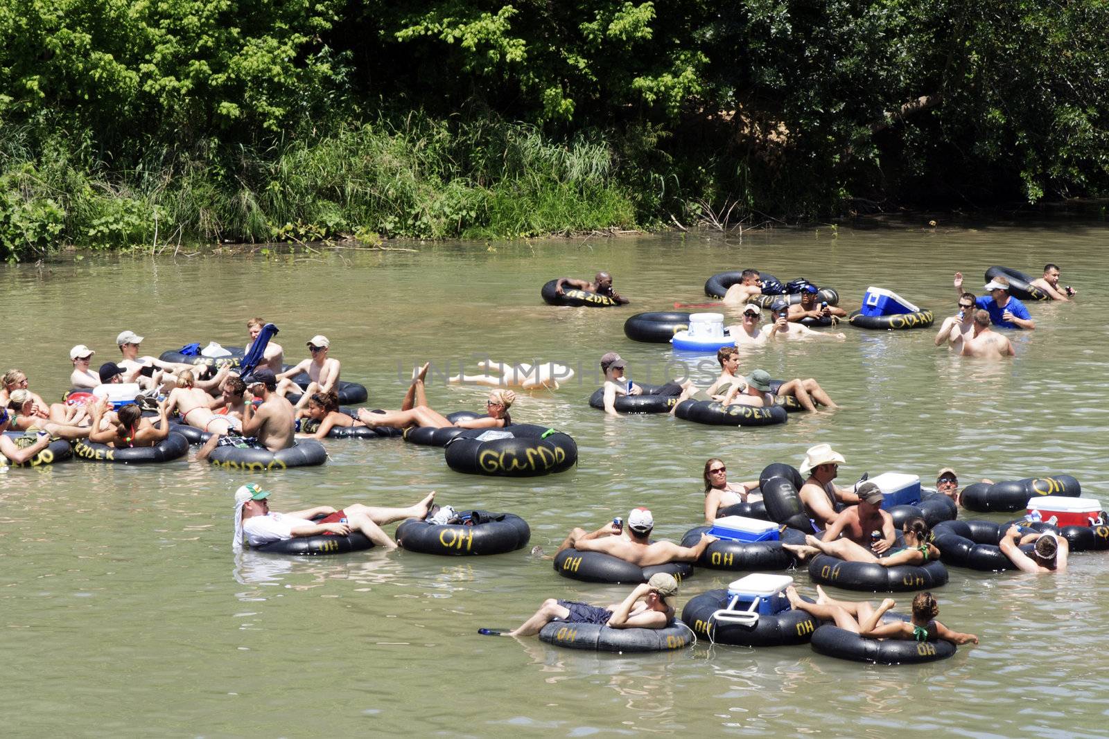 NEW BRAUNFELS, TX – MAY 2009:  Several people flowing down the Guadalupe River known for its large increased visitor traffic for the summer time.  Tubers where taken on May 30th, 2009 in New Braunfels, Texas.