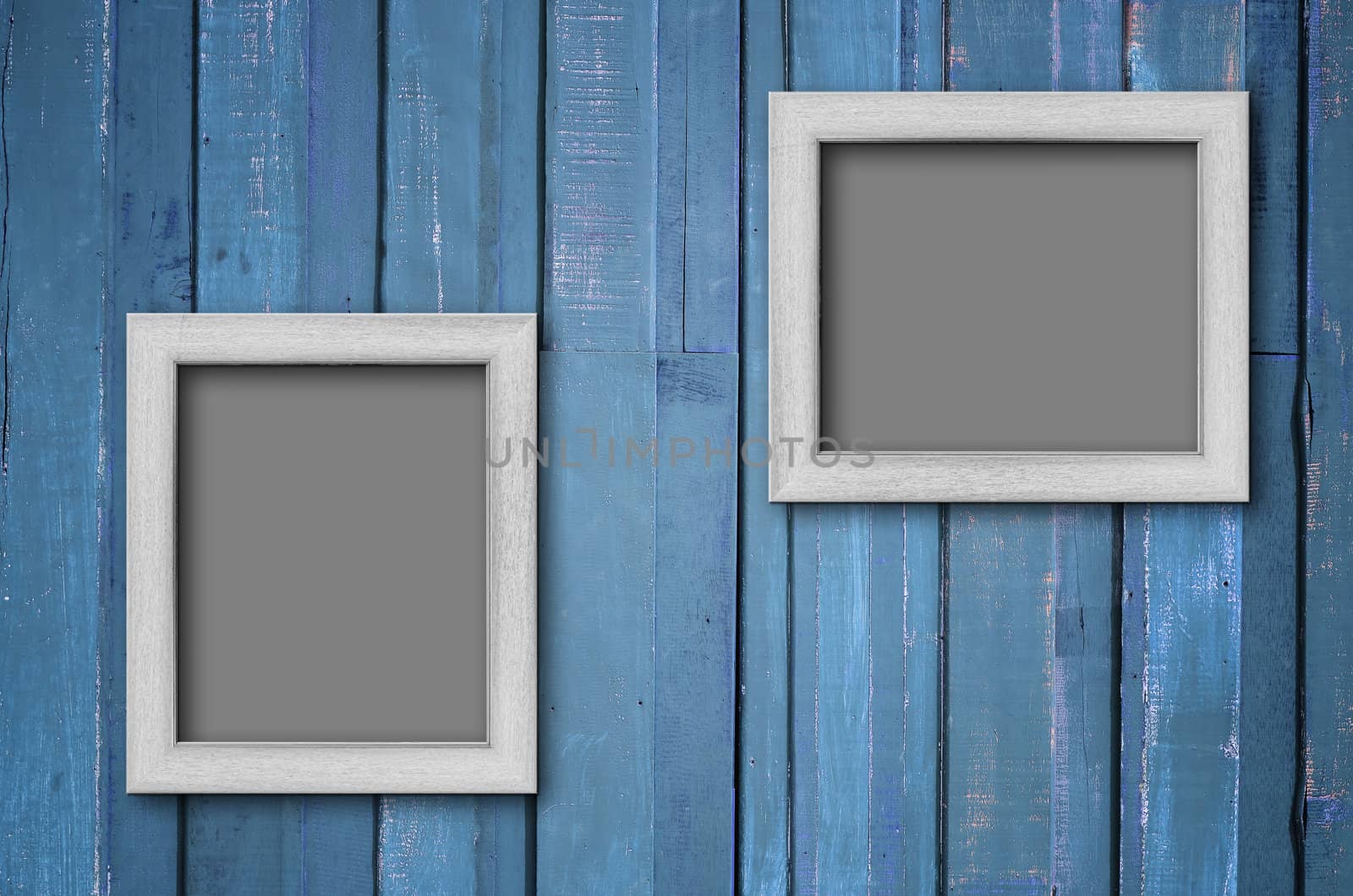 Two white wood picture frame on Blue color paint plank wall for background