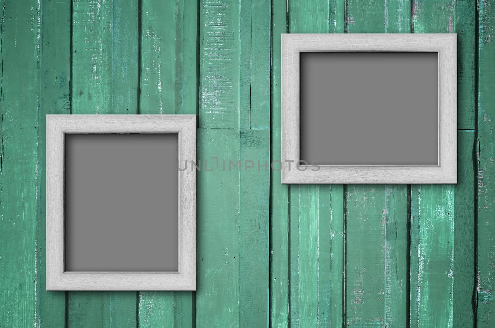 Two white wood picture frame on Green color paint plank wall for background