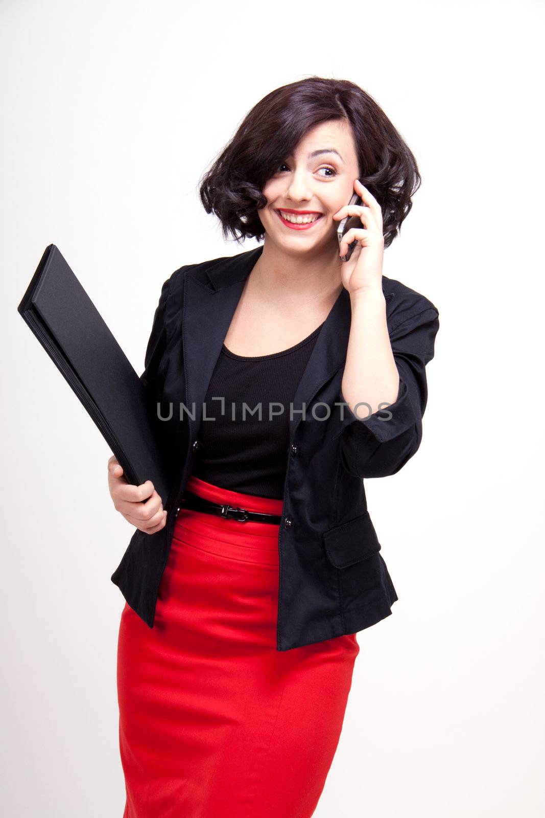 young business woman is talking on the mobile phone by juniart